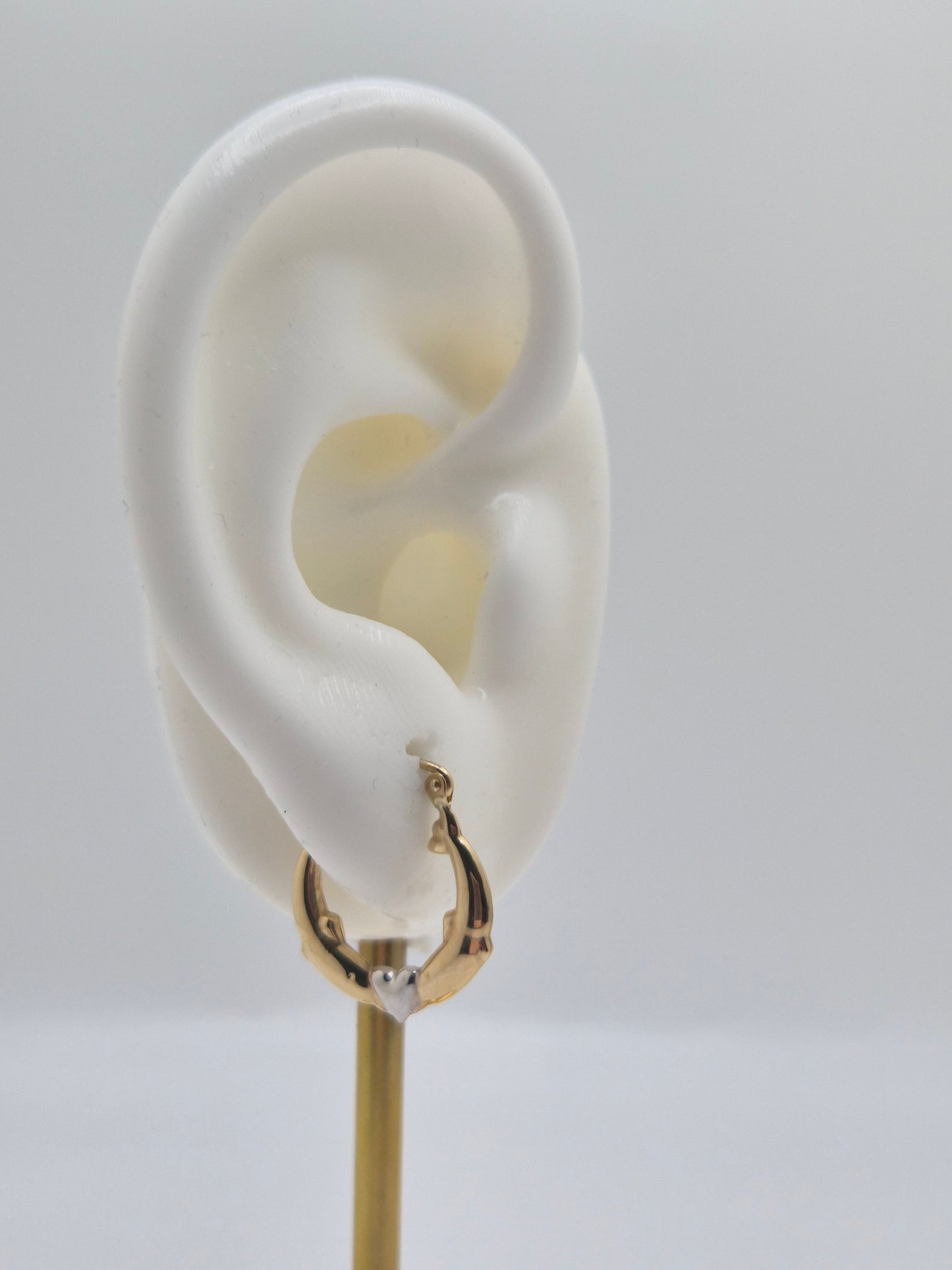 14K two-tone gold dolphin hoop earrings forming a heart design, 17mm lightweight hollow hoops.