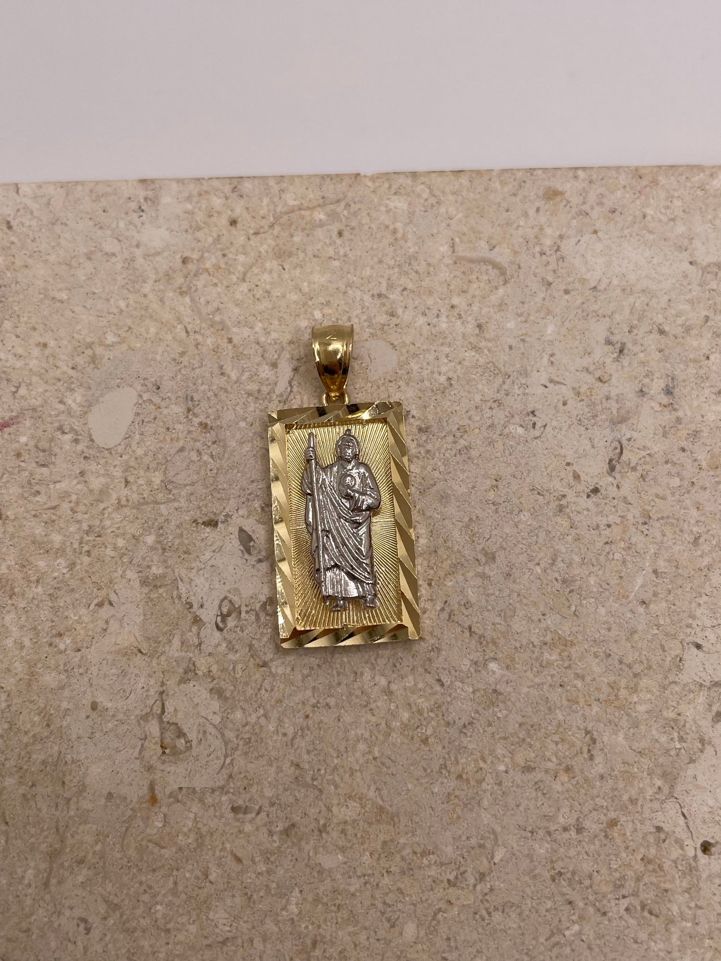 Close-up view of 14K two-tone gold San Judas pendant showcasing the intricate diamond-cut border and detailed Saint Jude design