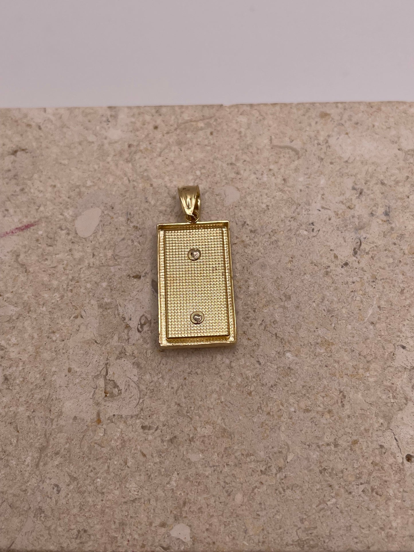 Back view of 14K two-tone gold San Judas pendant showing the smooth finish and craftsmanship