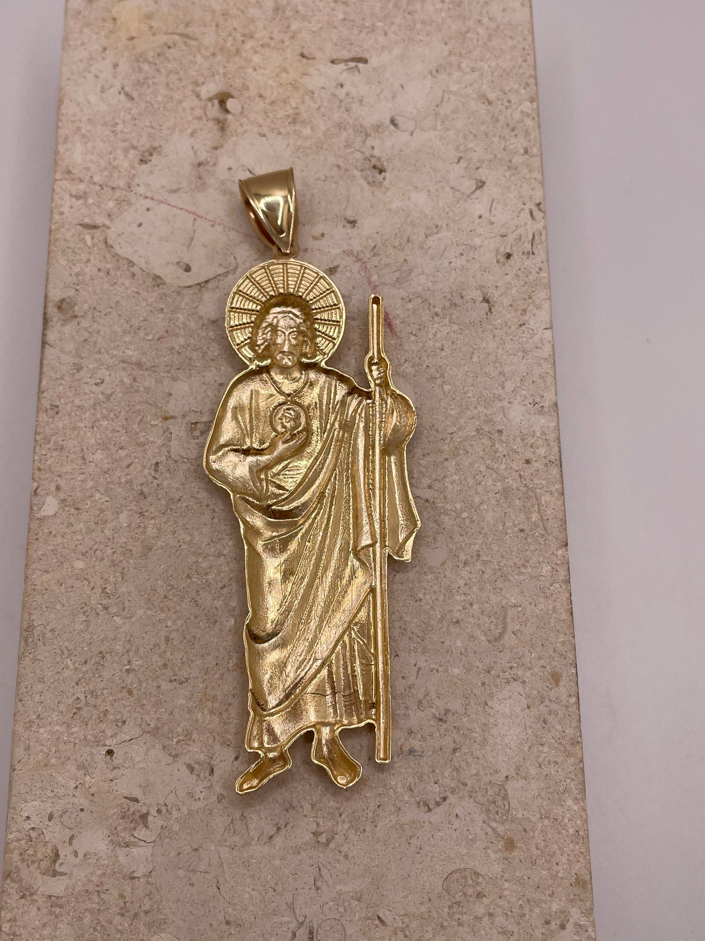 Back view of 14K yellow gold large San Judas pendant with smooth polished finish