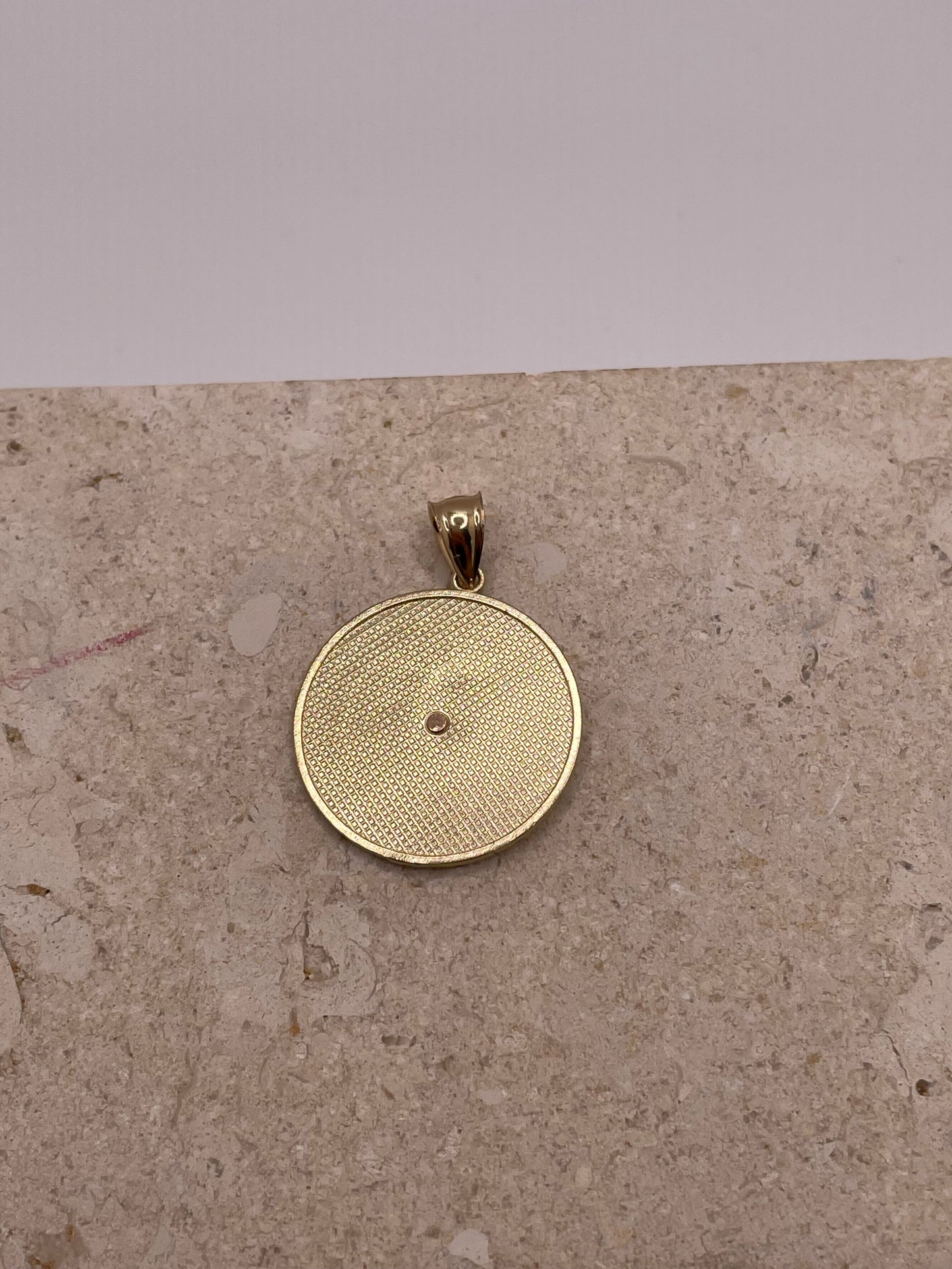 Back view of 14K gold Nuestra Senora De Guadalupe pendant, showing smooth finish and craftsmanship