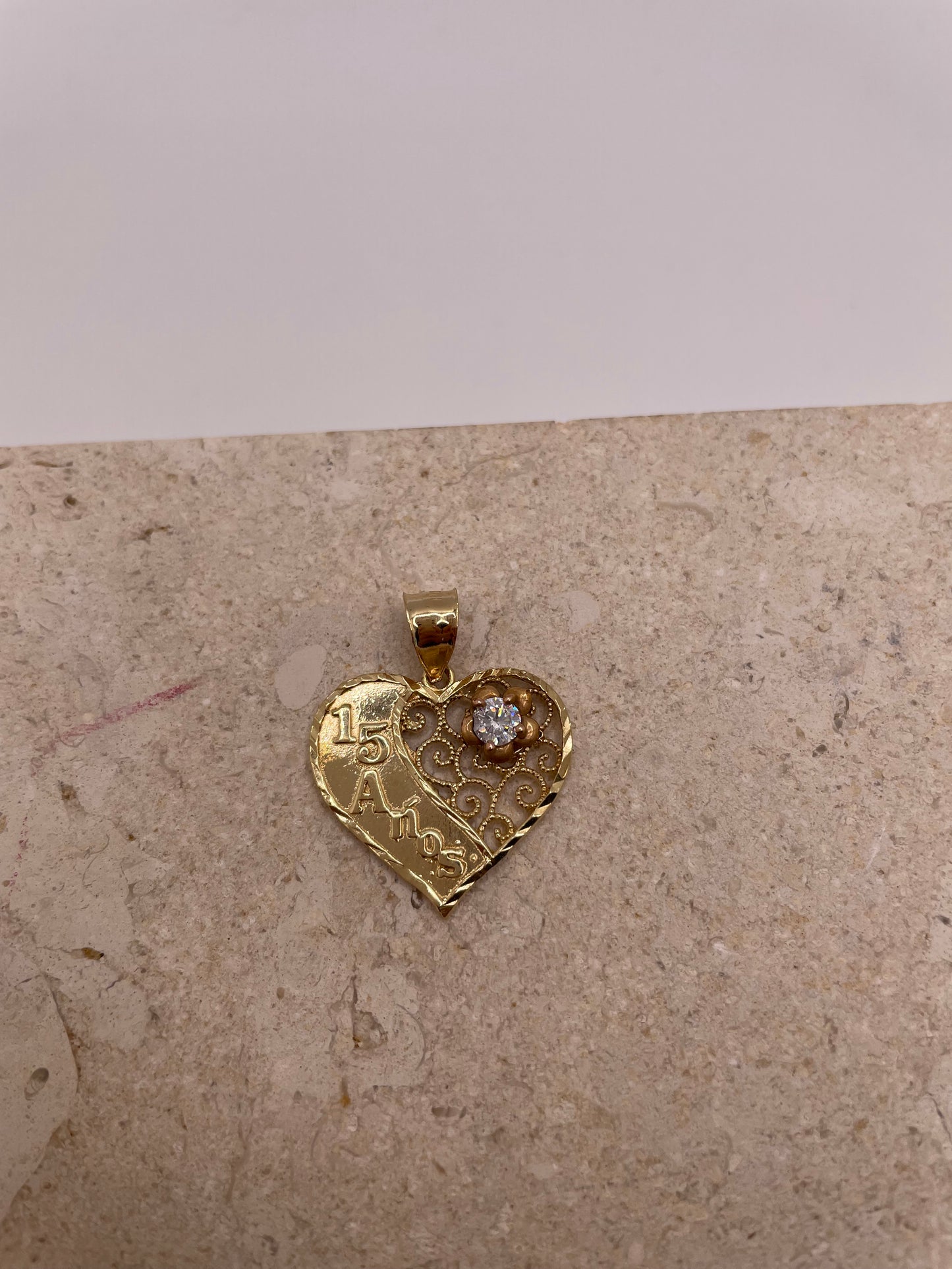 Close-up of 14k Gold '15' Quinceañera pendant with rose gold flower and CZ detail
