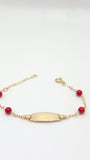 Pulsera de identificación de bebé con coral en oro amarillo de 14 quilates