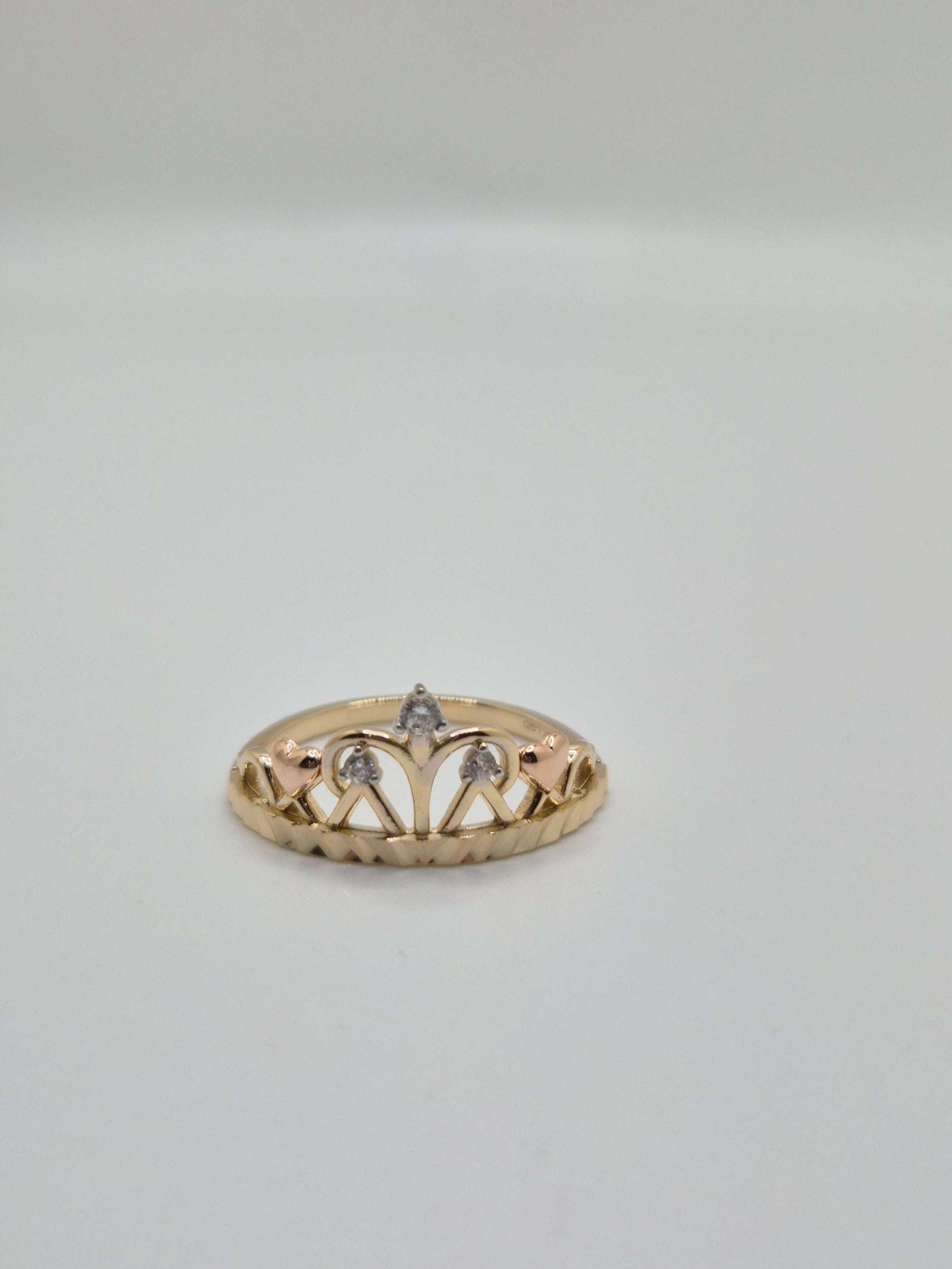 14K yellow gold crown-inspired ring with CZ accents and rose gold hearts, dainty princess style fine jewelry.