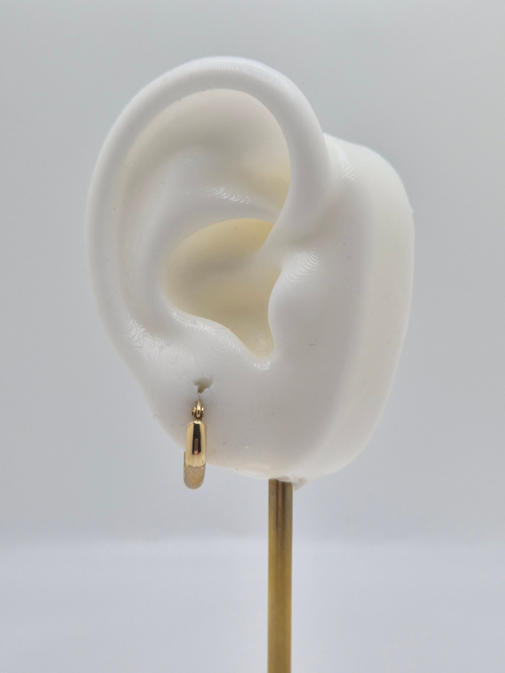 14K yellow gold mini hoop earrings with diamond-cut satin finish, 15mm lightweight everyday hoops.