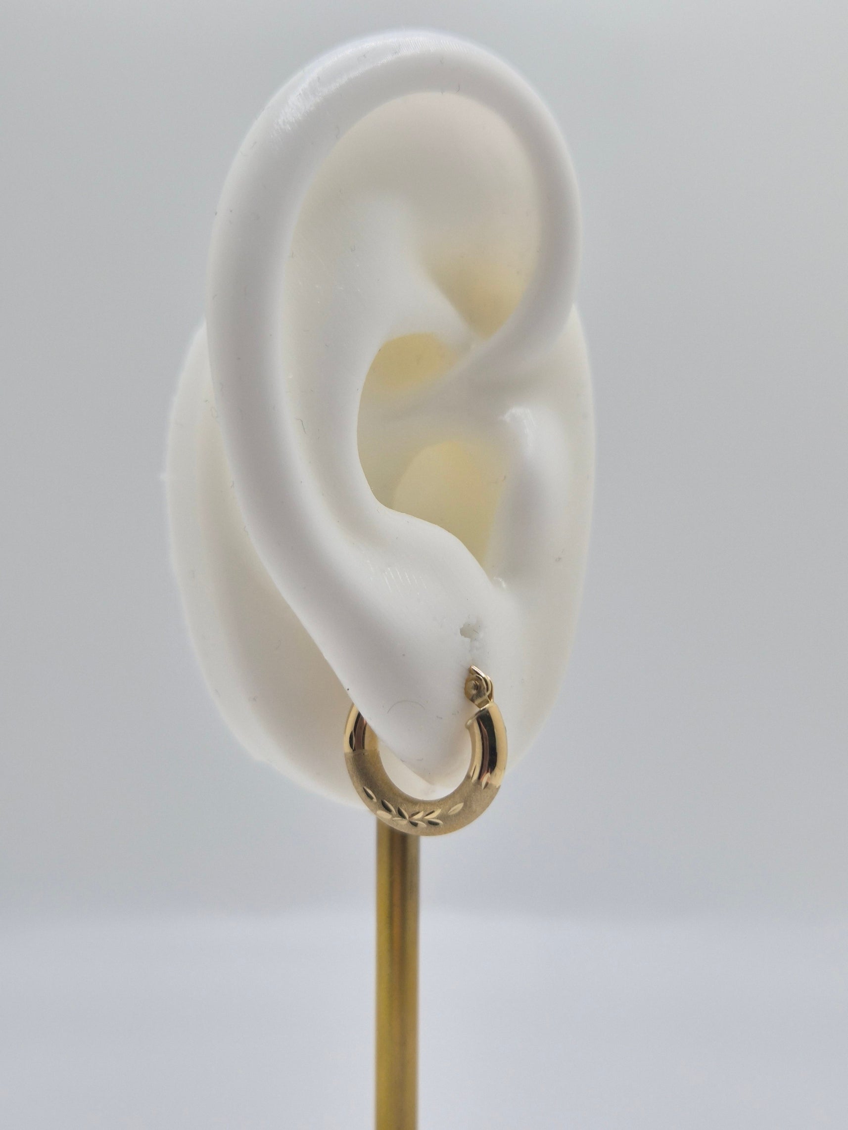 14K yellow gold mini hoop earrings with diamond-cut satin finish, 15mm lightweight everyday hoops.