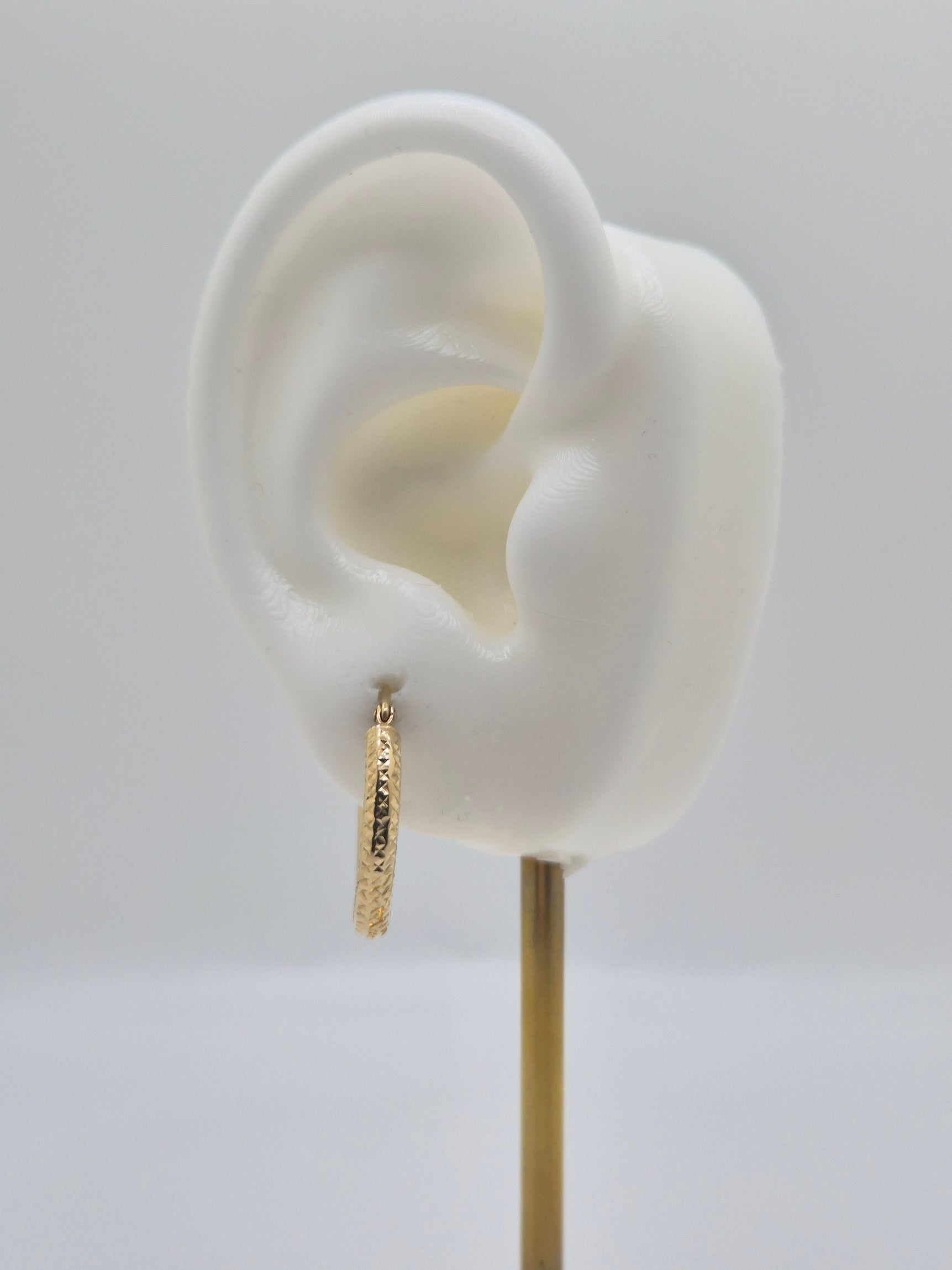 14K yellow gold diamond-cut mini hoop earrings, 20mm round lightweight design with textured shine.