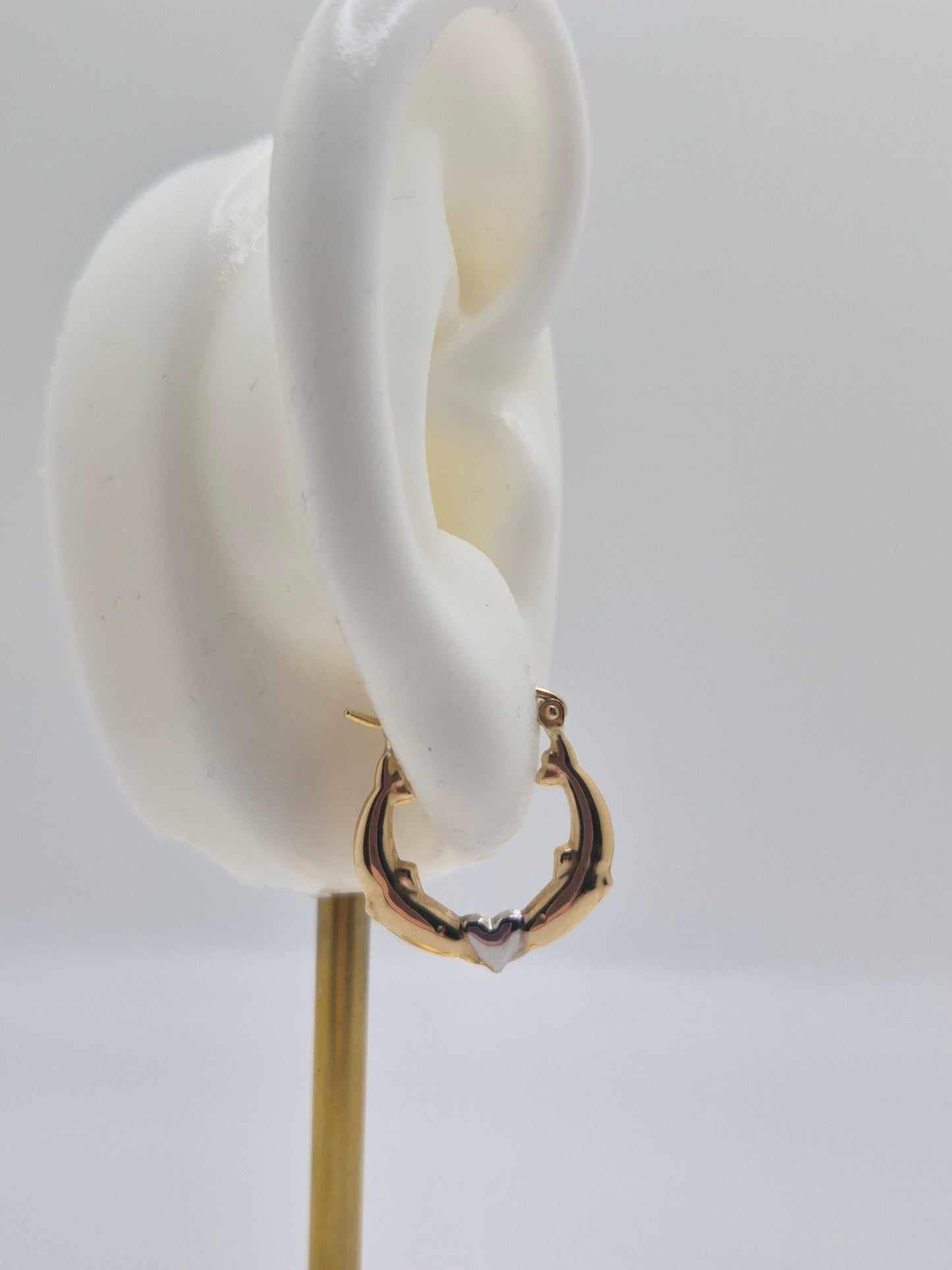 14K two-tone gold dolphin hoop earrings forming a heart design, 17mm lightweight hollow hoops.