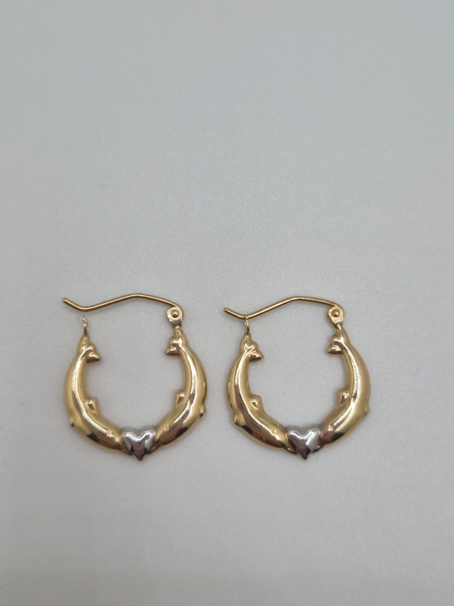 14K two-tone gold dolphin hoop earrings forming a heart design, 17mm lightweight hollow hoops.