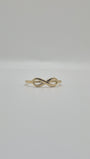 14K yellow gold infinity ring with polished finish, minimal everyday stacking band symbolizing eternal love.