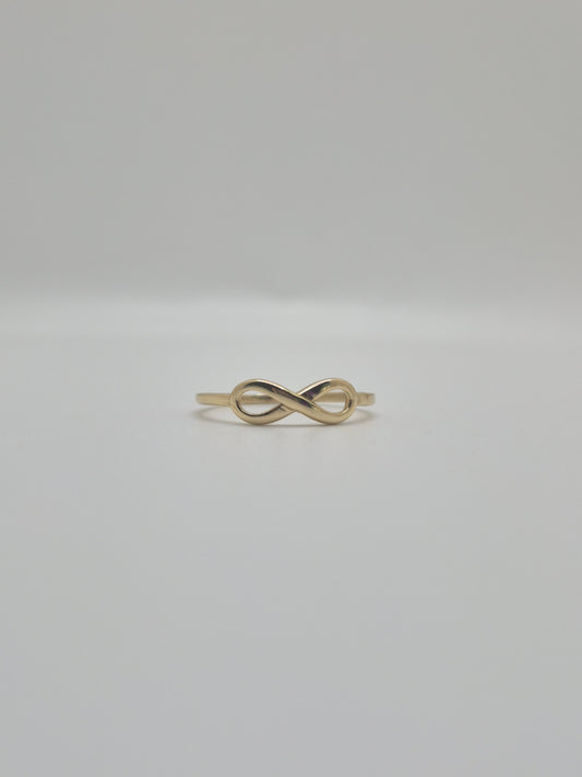14K yellow gold infinity ring with polished finish, minimal everyday stacking band symbolizing eternal love.