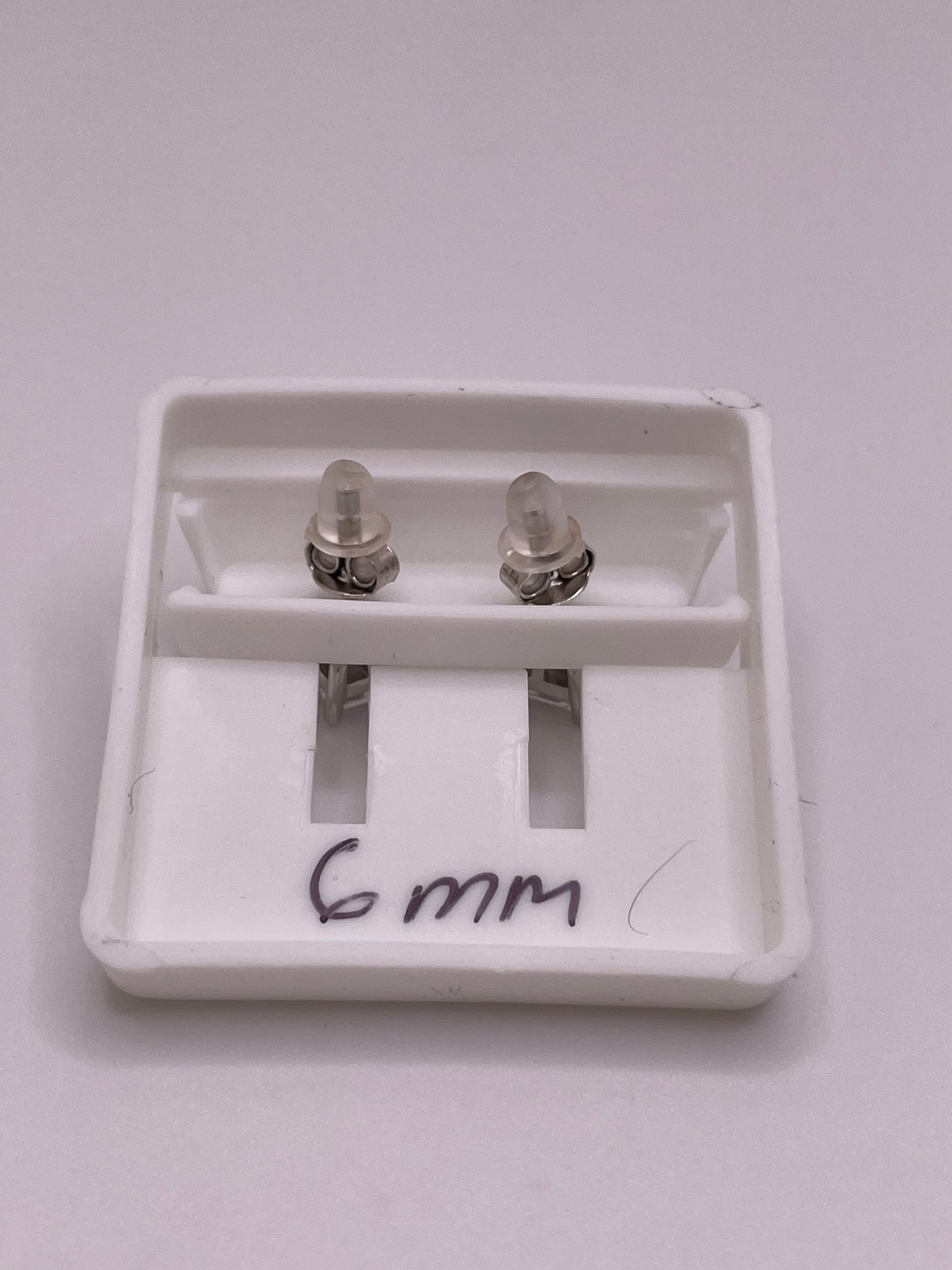 Sterling silver princess-cut CZ stud earrings in 5mm and 6mm, with butterfly backs, sold individually or as a set.