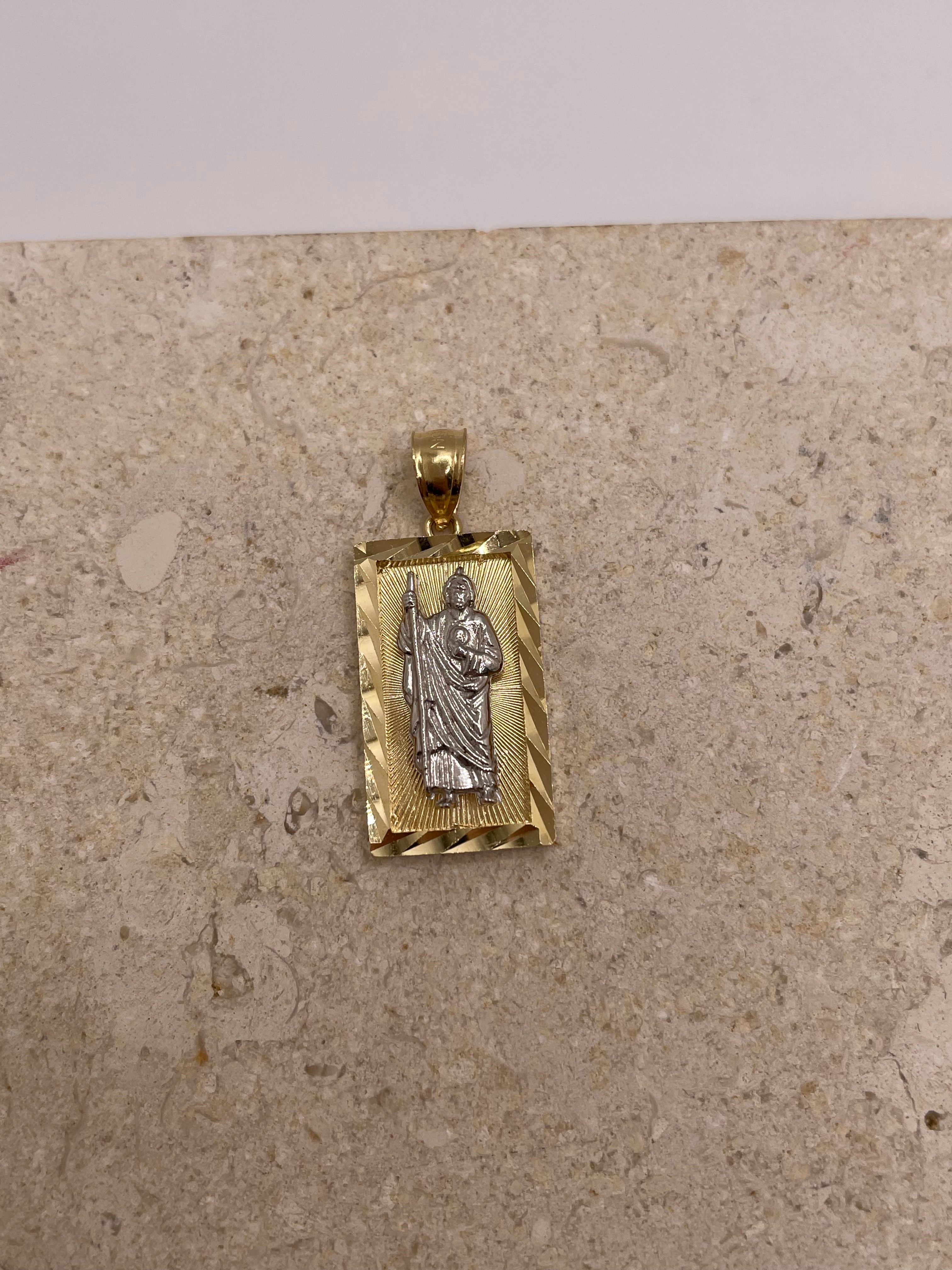 Close-up view of 14K two-tone gold San Judas pendant showcasing the intricate diamond-cut border and detailed Saint Jude design