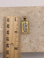 14K two-tone gold San Judas pendant next to a ruler showing dimensions of the pendant and bai