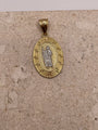 Close-up of 14K yellow gold oval San Judas pendant highlighting the white gold Saint Jude and fancy border details