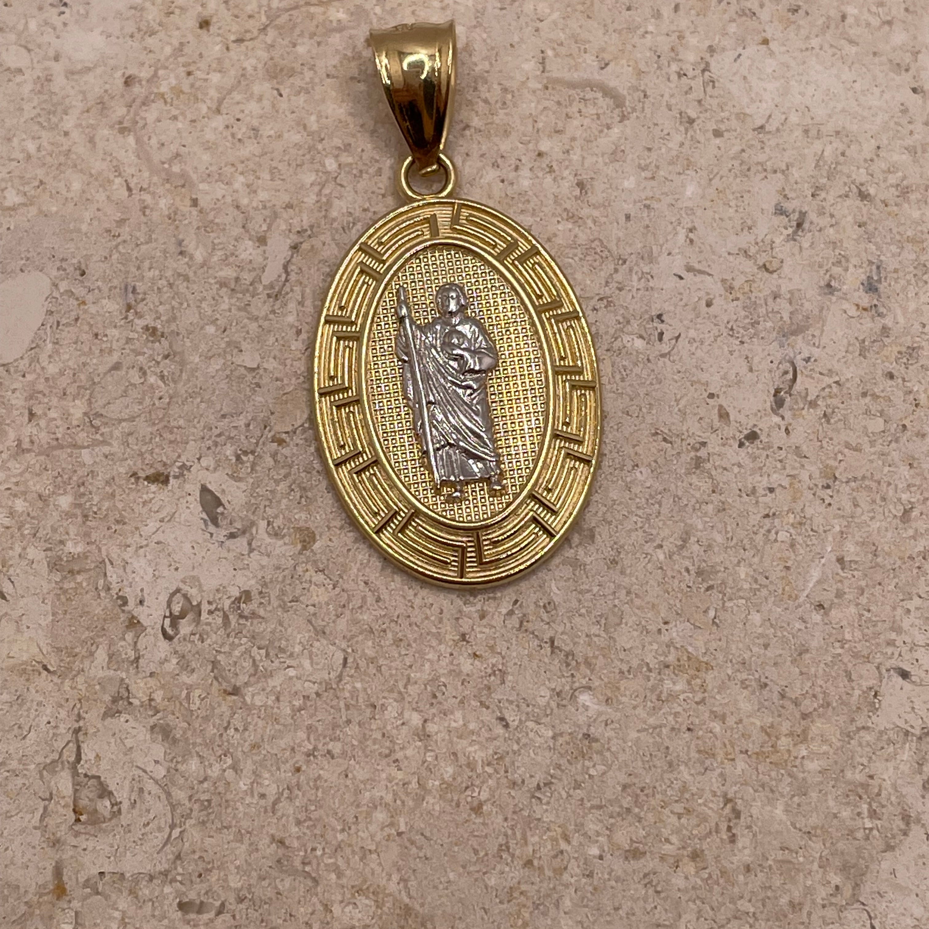 Close-up of 14K yellow gold oval San Judas pendant highlighting the white gold Saint Jude and fancy border details