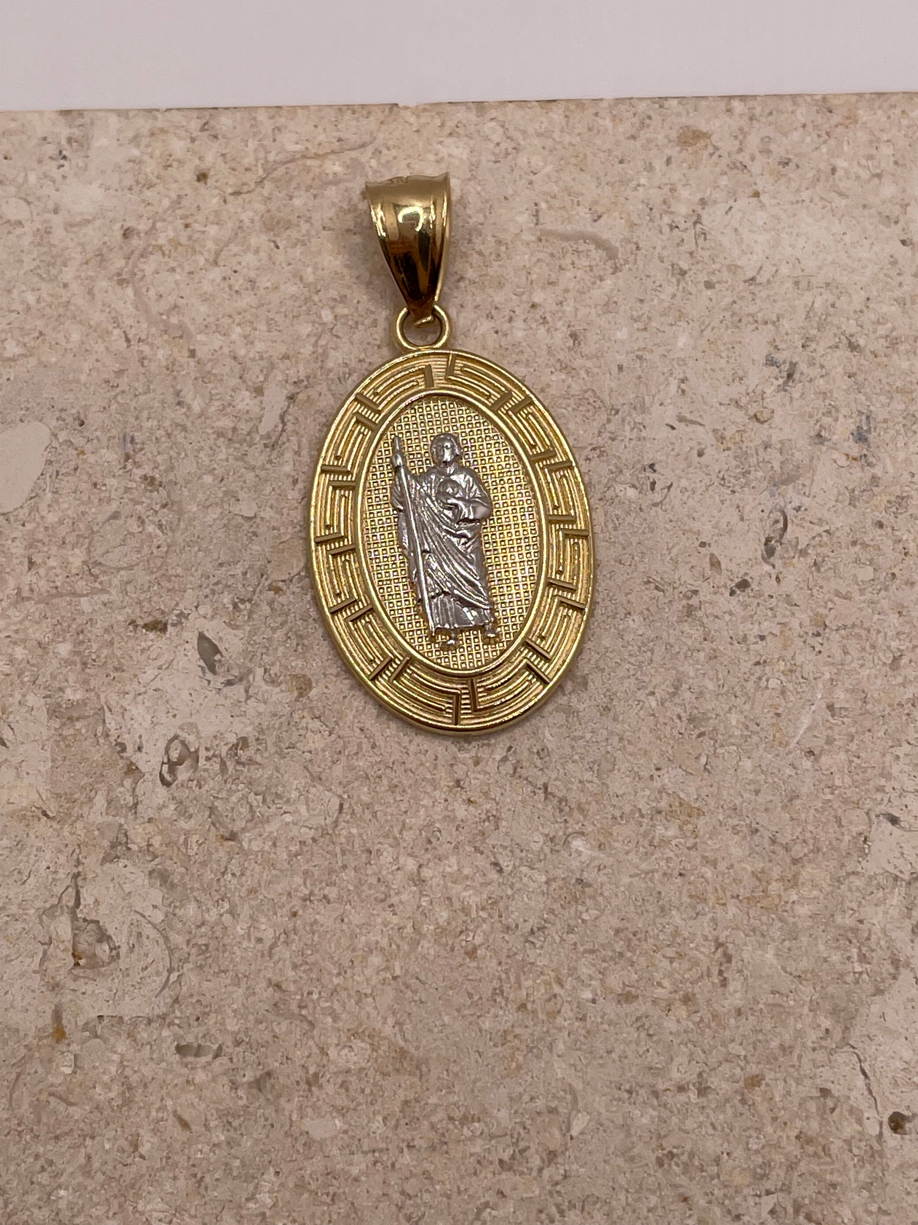 Close-up of 14K yellow gold oval San Judas pendant highlighting the white gold Saint Jude and fancy border details