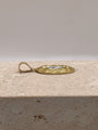 Side view of 14K yellow gold oval San Judas pendant emphasizing the bail size and design