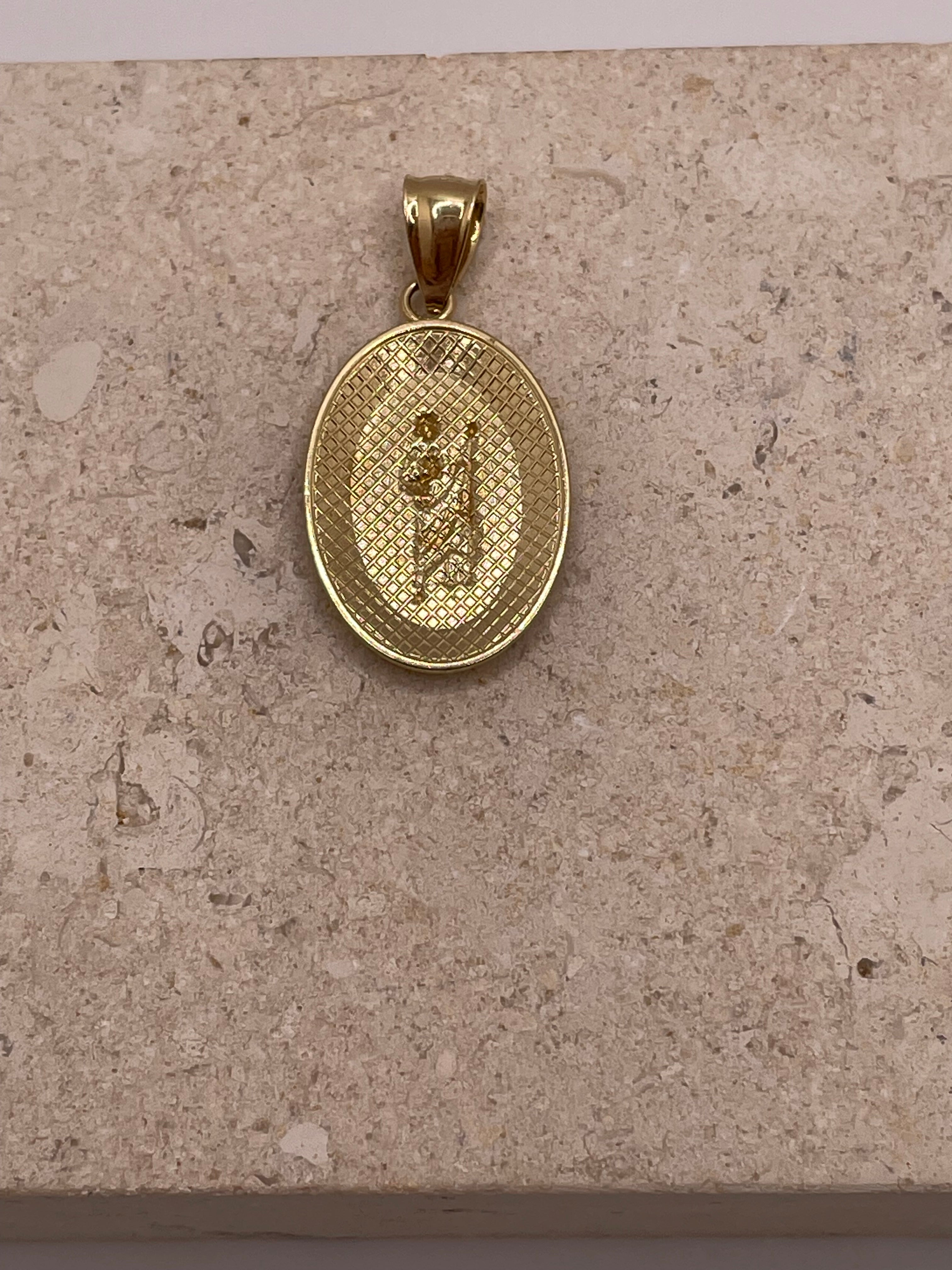 Back view of 14K yellow gold oval San Judas pendant showing the polished finish