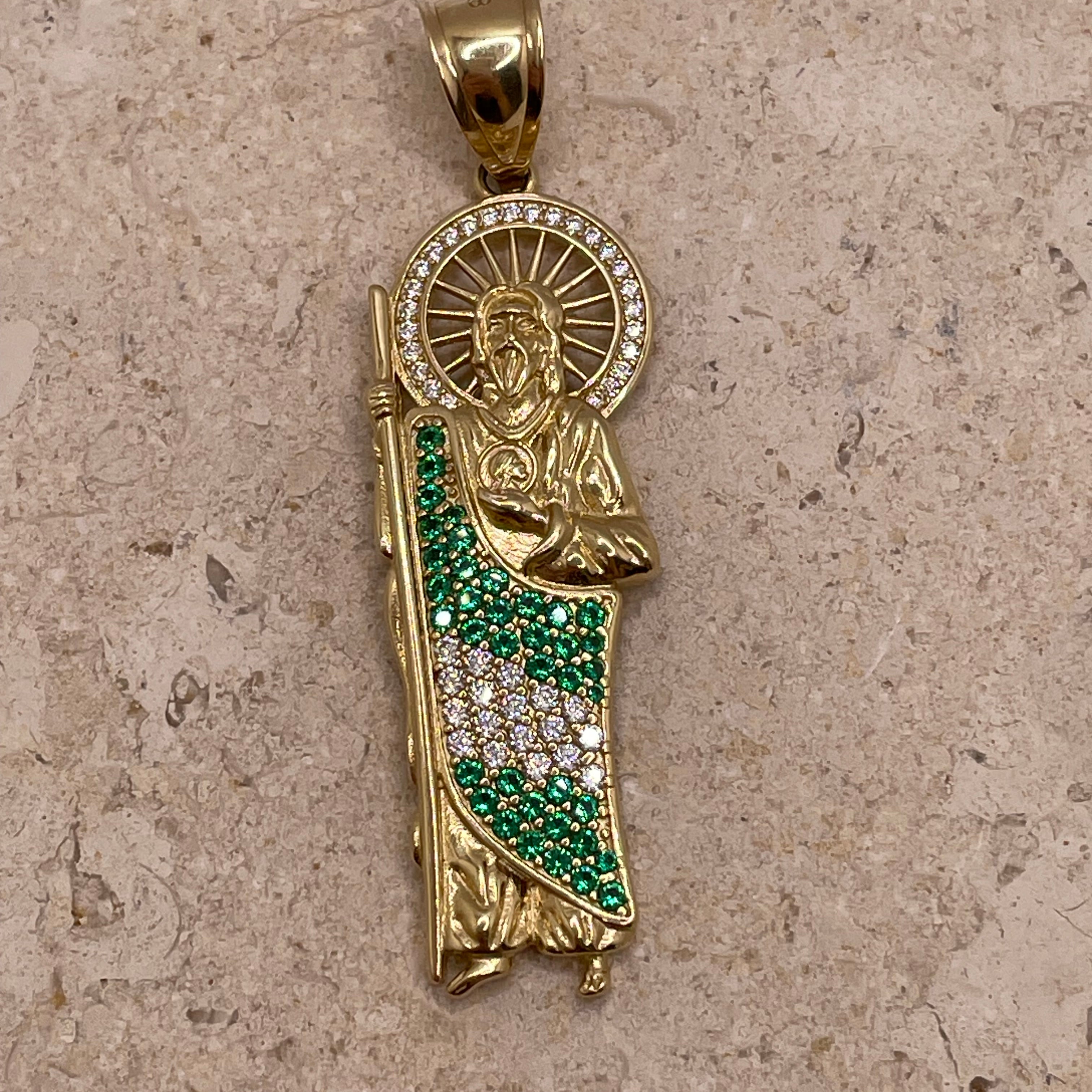 Close-up of 14K yellow gold San Judas pendant showcasing the CZ halo around Saint Jude’s head and the green and white CZ body detail