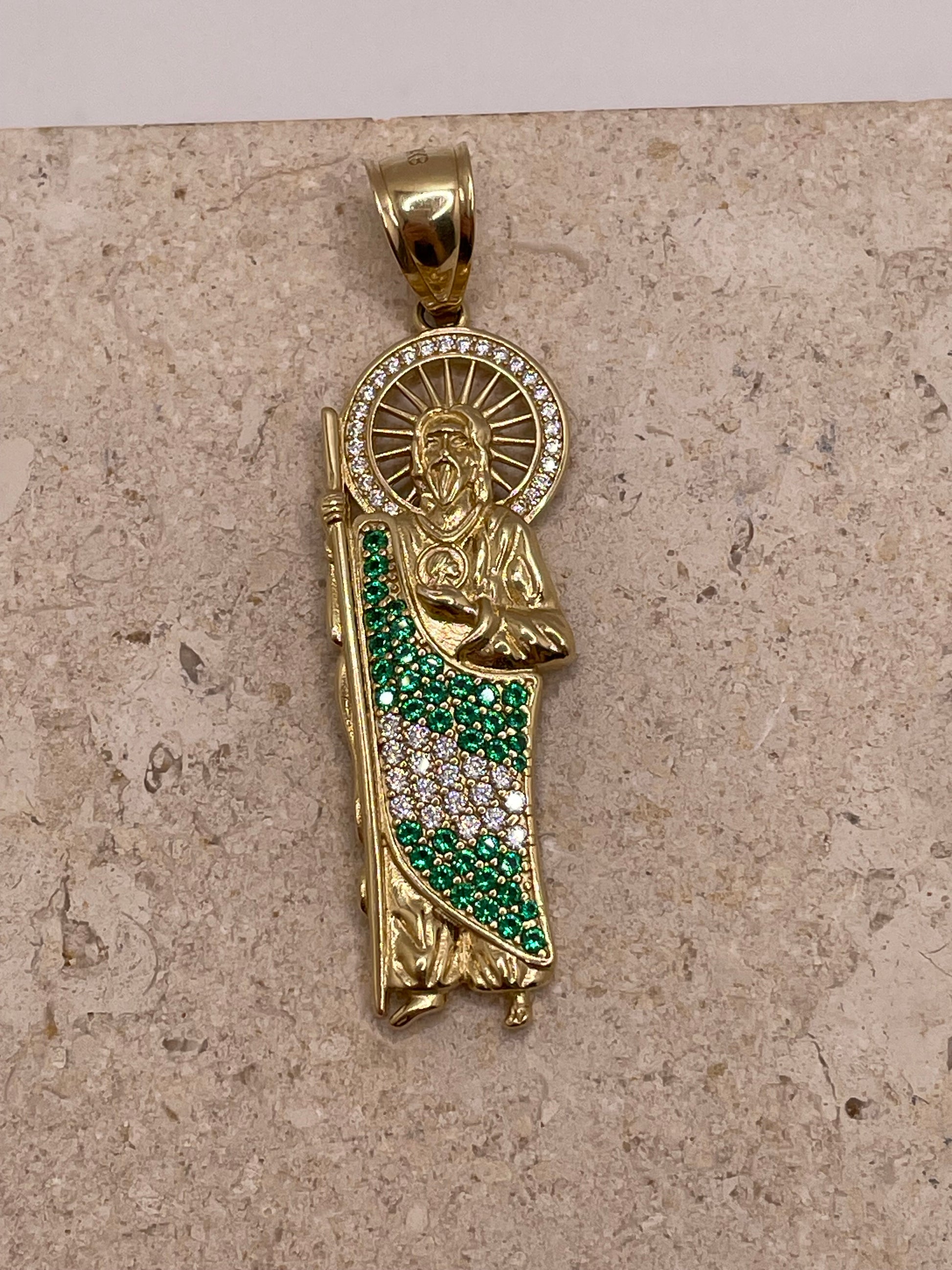 Close-up of 14K yellow gold San Judas pendant showcasing the CZ halo around Saint Jude’s head and the green and white CZ body detail