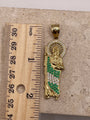 14K yellow gold San Judas pendant with CZ halo and green and white CZ details, shown next to a ruler to display dimensions (approximately 2 inches)