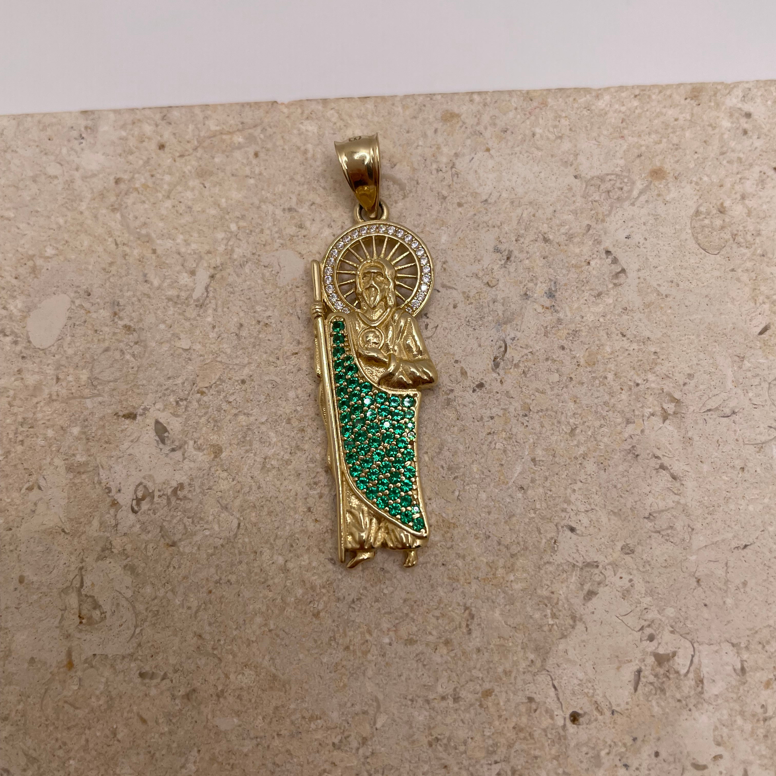 Close-up of 14K yellow gold San Judas pendant showcasing the CZ halo around Saint Jude’s head and green CZ body details