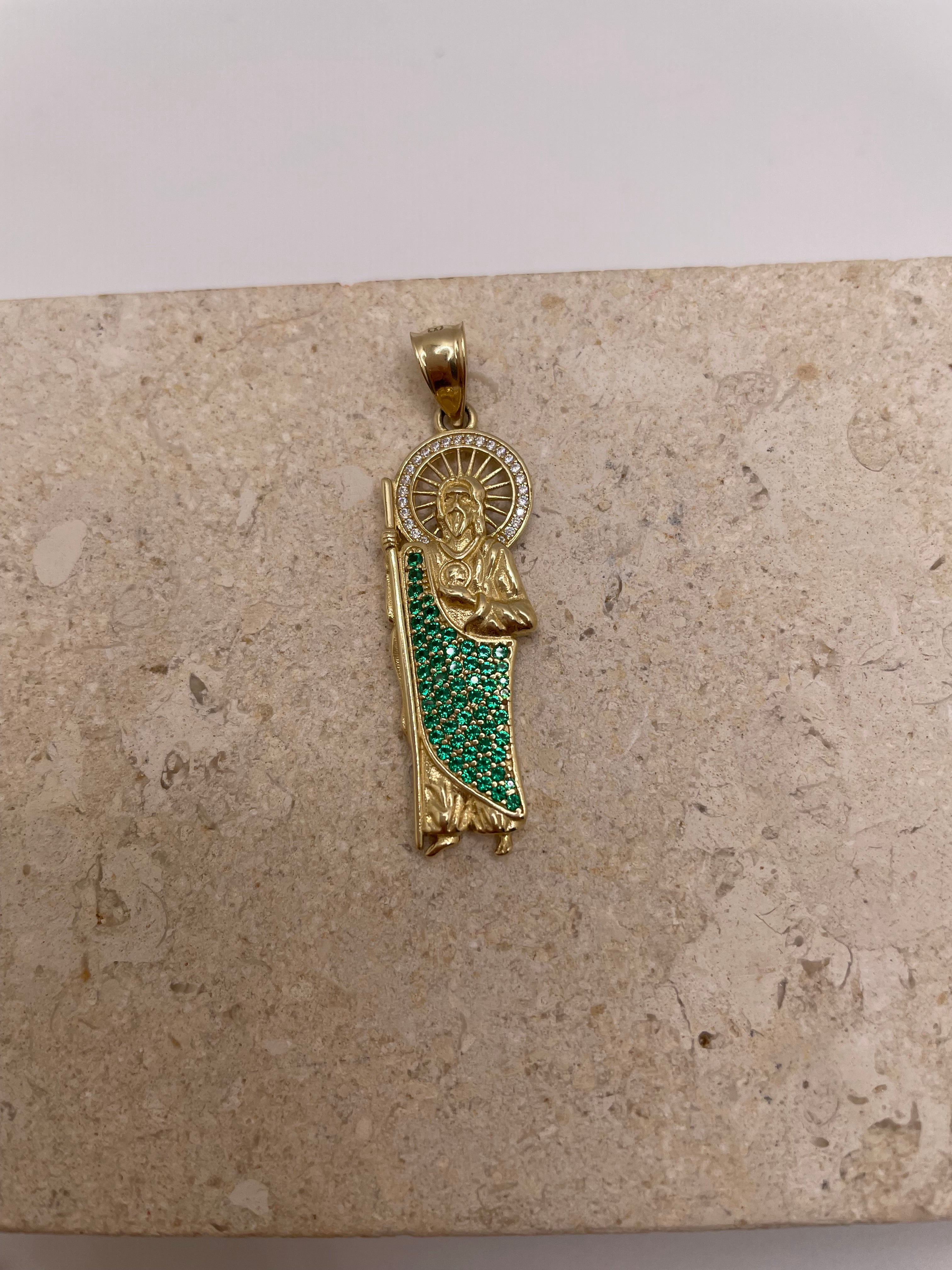 Close-up of 14K yellow gold San Judas pendant showcasing the CZ halo around Saint Jude’s head and green CZ body details