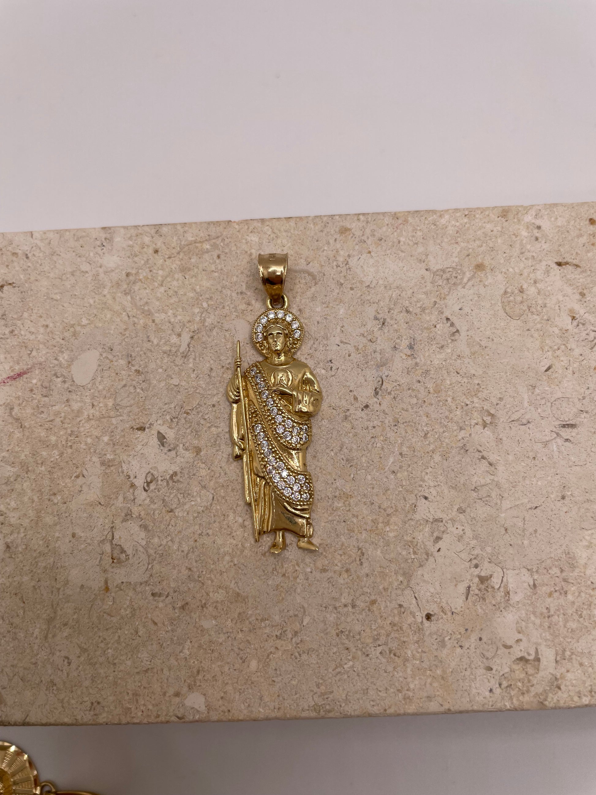 Close-up of 14K yellow gold San Judas pendant with white CZ stones in a halo around his head and on his body