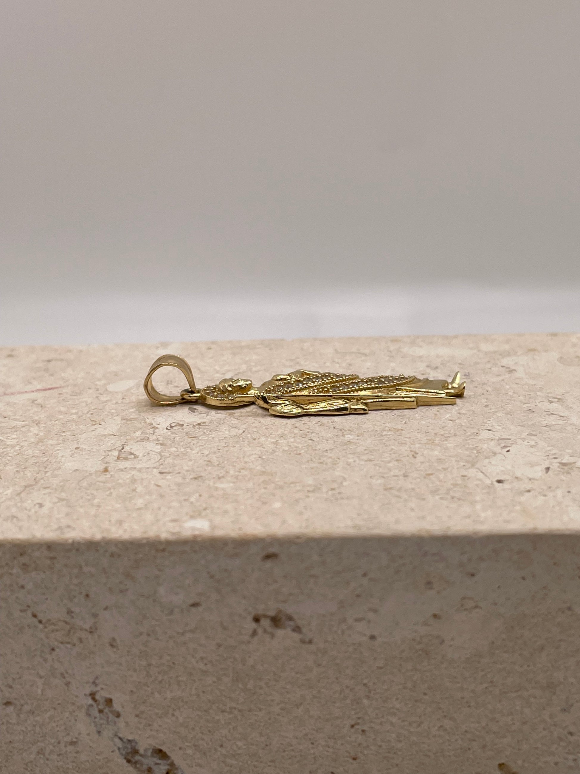 Side view of 14K yellow gold San Judas pendant showing the bail design and size