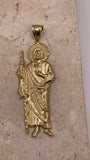 Close-up of 14K yellow gold large San Judas pendant with detailed craftsmanship and gold finish