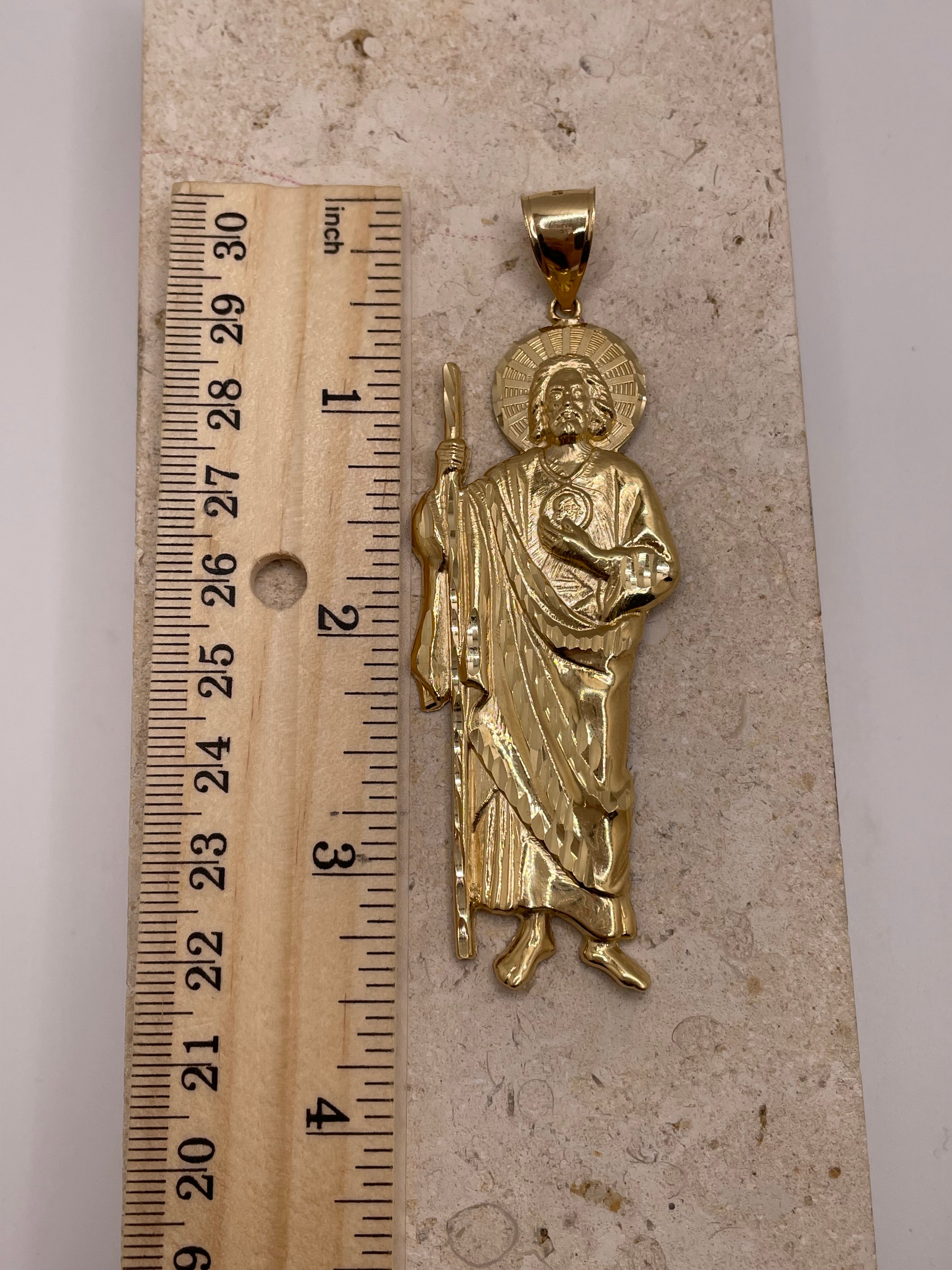 14K yellow gold large San Judas pendant shown next to a ruler to display dimensions (approximately 3.5 inches)