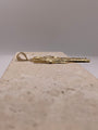 Side view of 14K yellow gold San Judas pendant highlighting the thickness and depth of the pendant