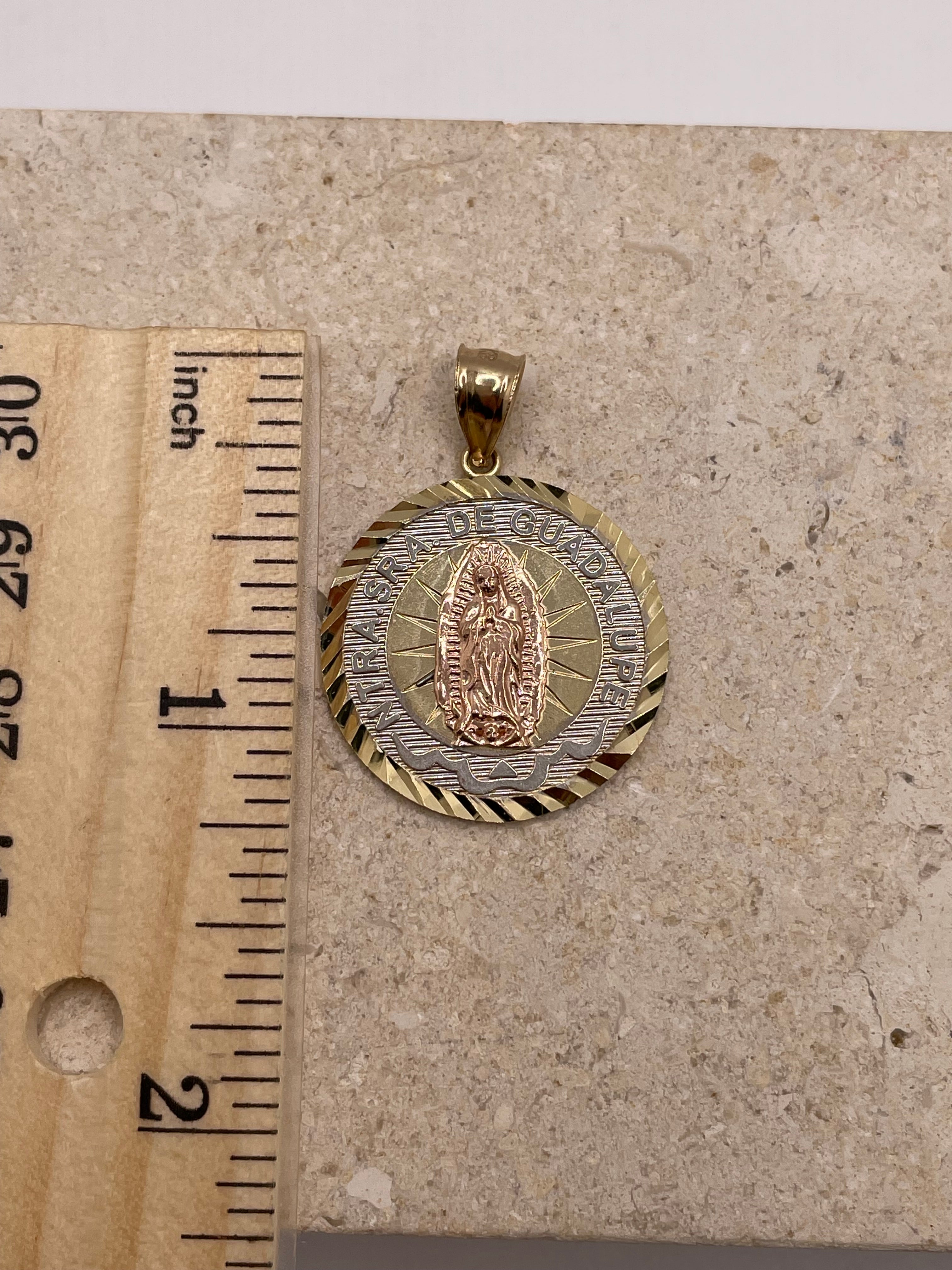 14K gold Nuestra Senora De Guadalupe pendant (25mm), shown next to a ruler to display dimensions