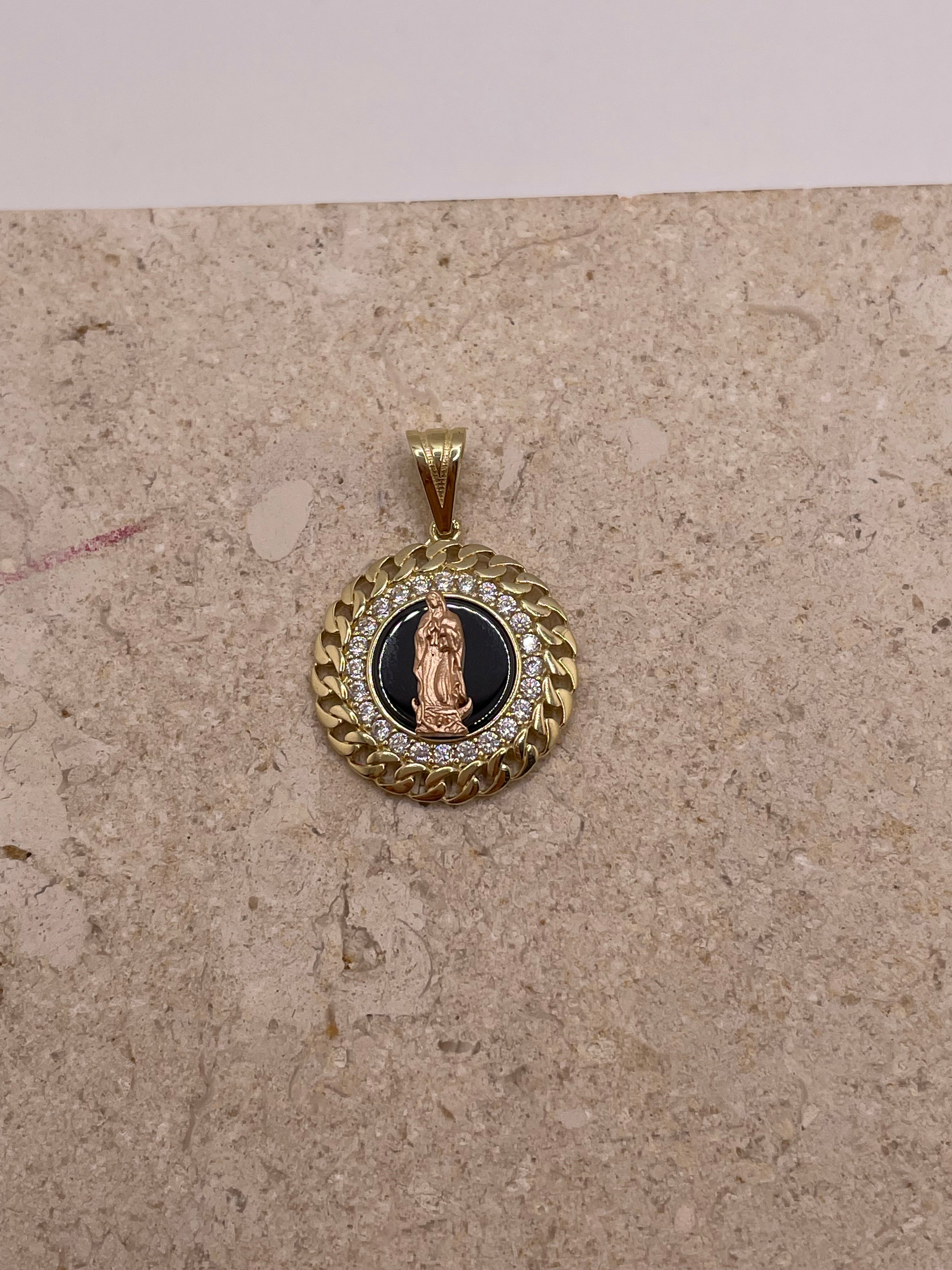 Close-up of 14K yellow gold Virgen De Guadalupe pendant showing black onyx center, rose gold Virgin Mary, CZ stones, and Cuban link-style border