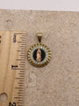 14K yellow gold Virgen De Guadalupe pendant with onyx, CZ stones, and rose gold Virgin Mary, shown next to a ruler to display dimensions