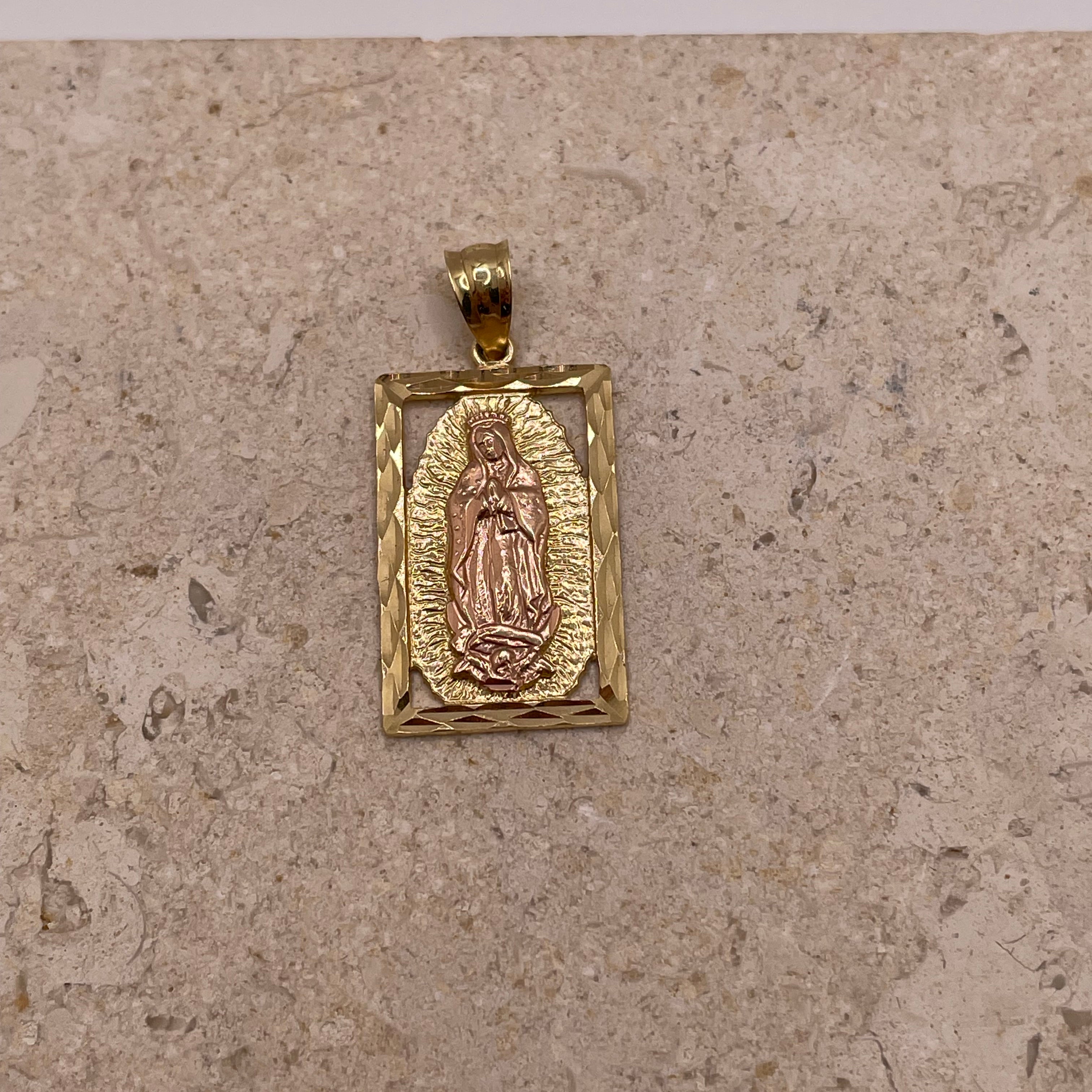 Close-up of 14K gold vertical Virgen Mary pendant with diamond-cut border and rose gold Virgin Mary surrounded by yellow gold design