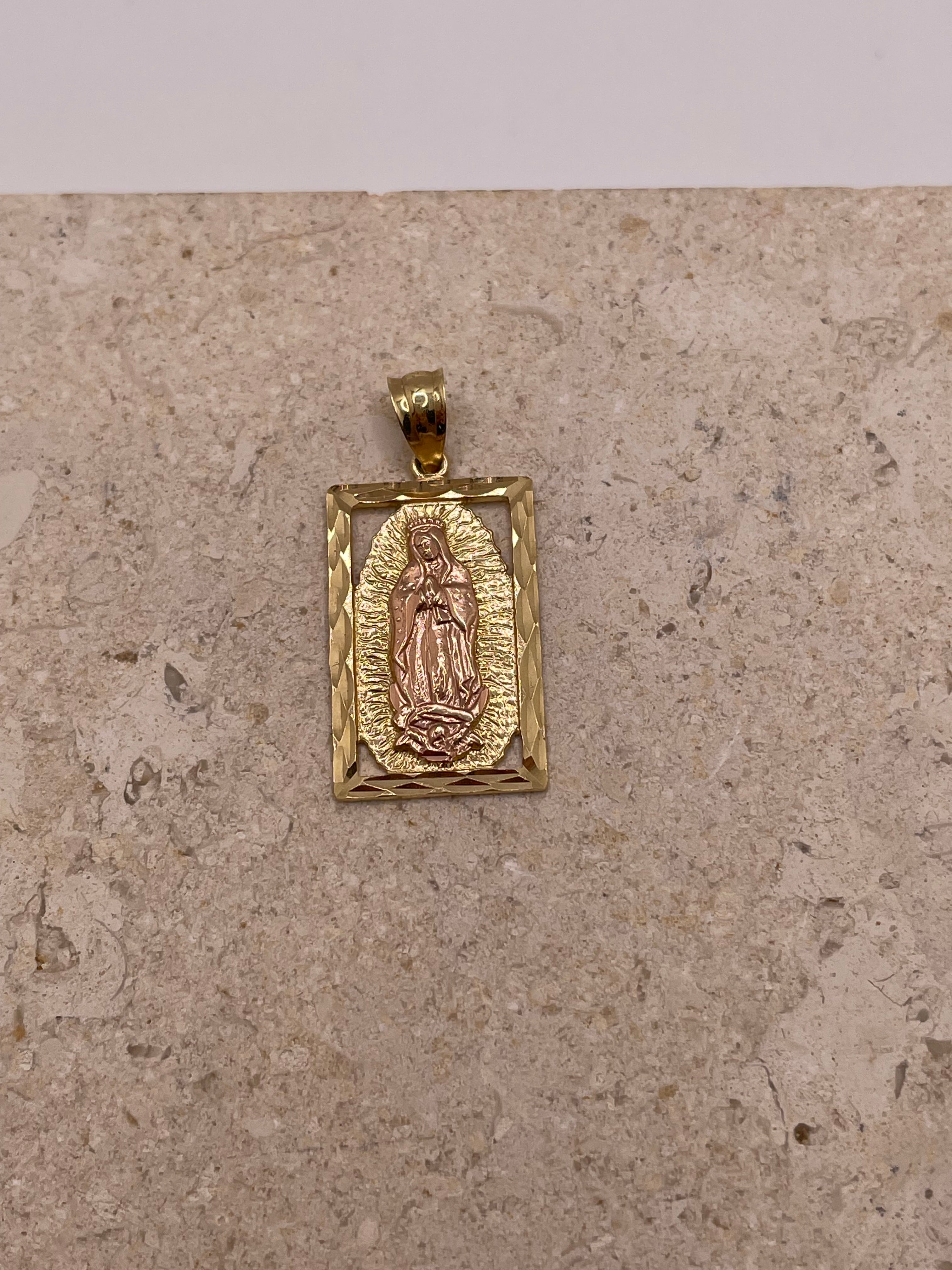 Close-up of 14K gold vertical Virgen Mary pendant with diamond-cut border and rose gold Virgin Mary surrounded by yellow gold design