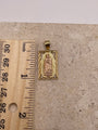 14K gold vertical Virgen Mary pendant with diamond-cut border, shown next to a ruler to display dimensions (21mm x 14mm)