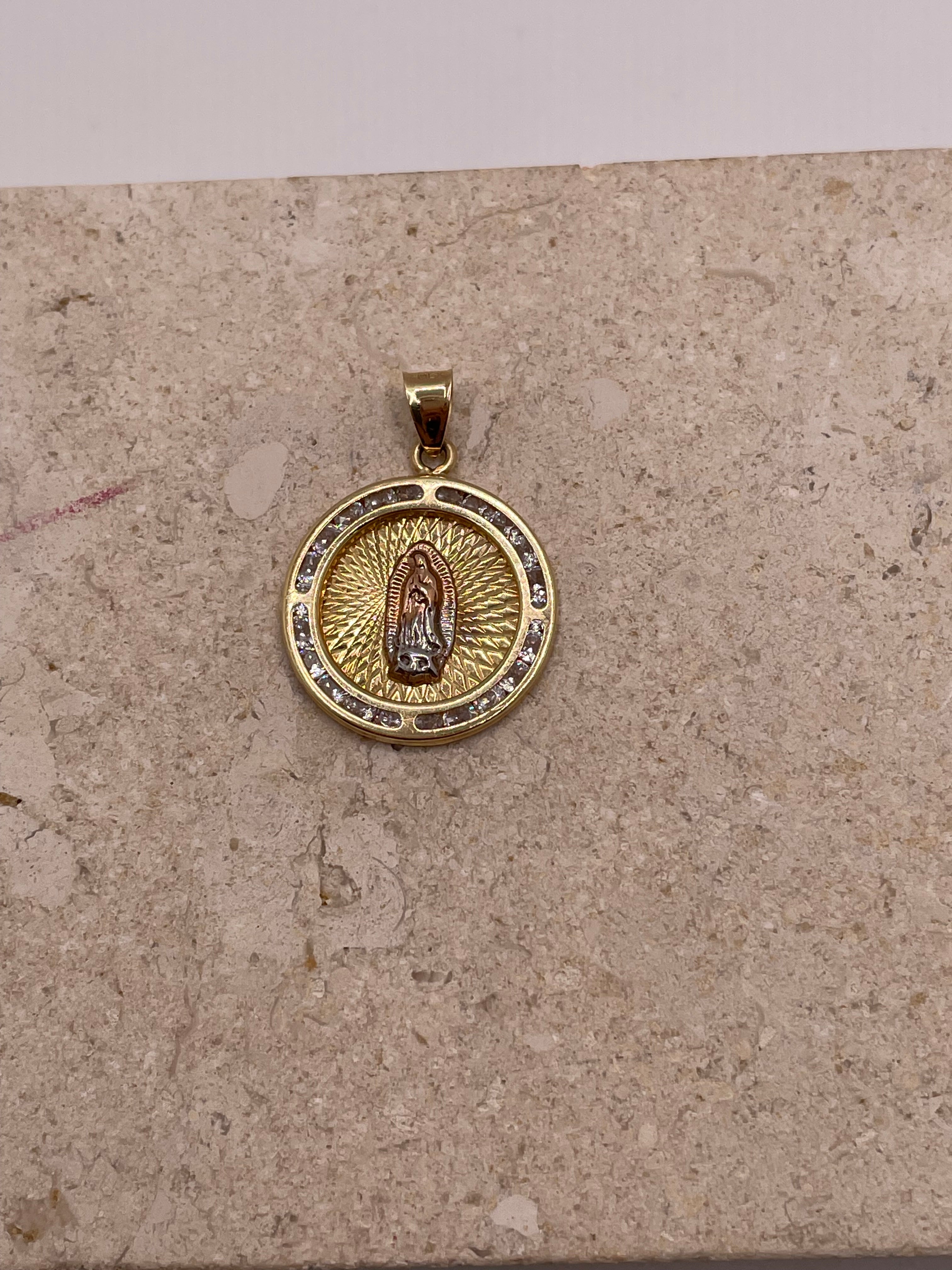 Close-up of 14K yellow gold Virgencita pendant with CZ border and white gold and rose gold Virgin Mary at the cente