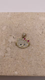 Close-up of 14K gold Hello Kitty pendant with white CZ stones, black CZ eyes and nose, and a pink CZ bow