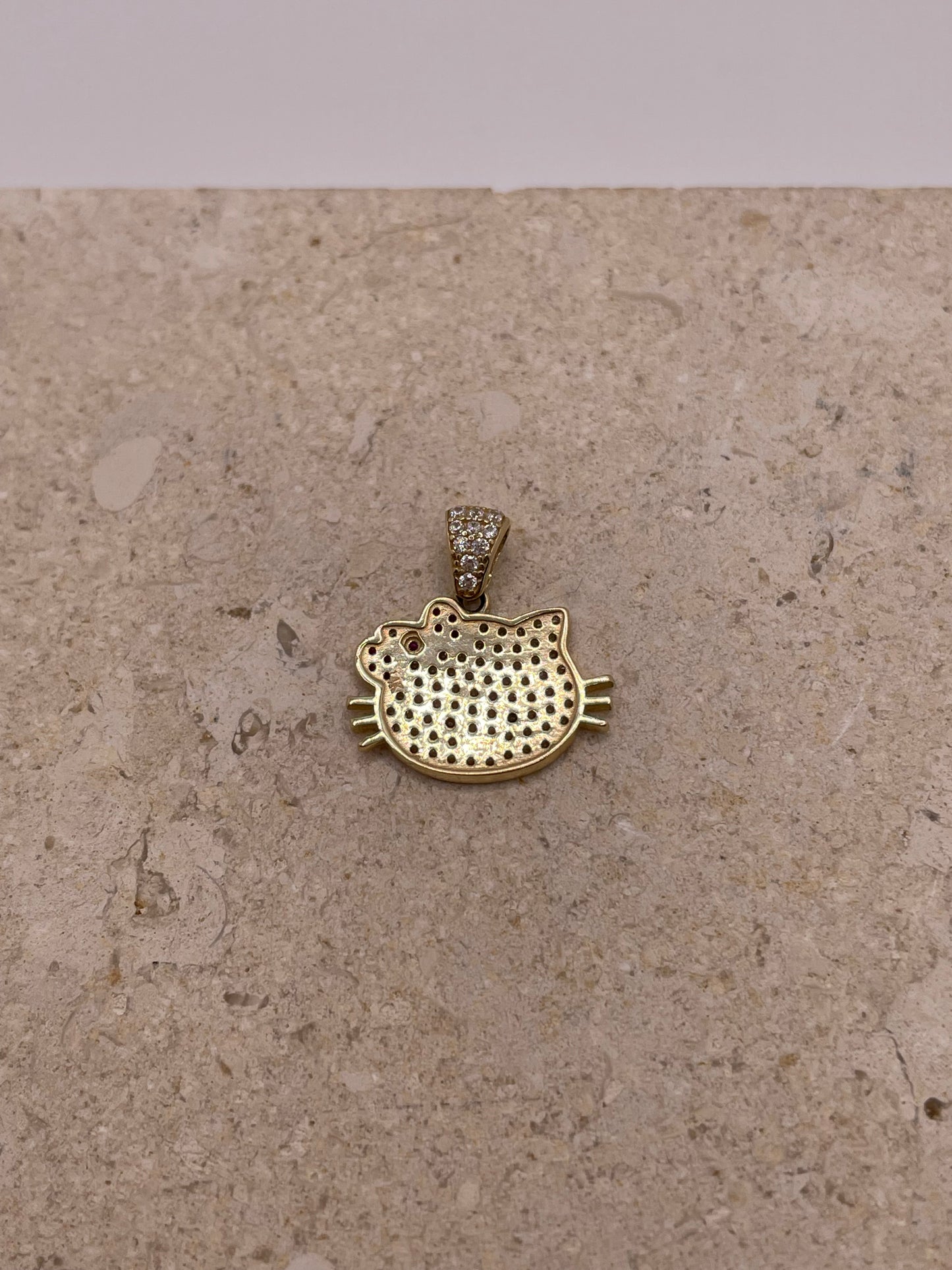 Back view of 14K gold Hello Kitty pendant with smooth polished finish