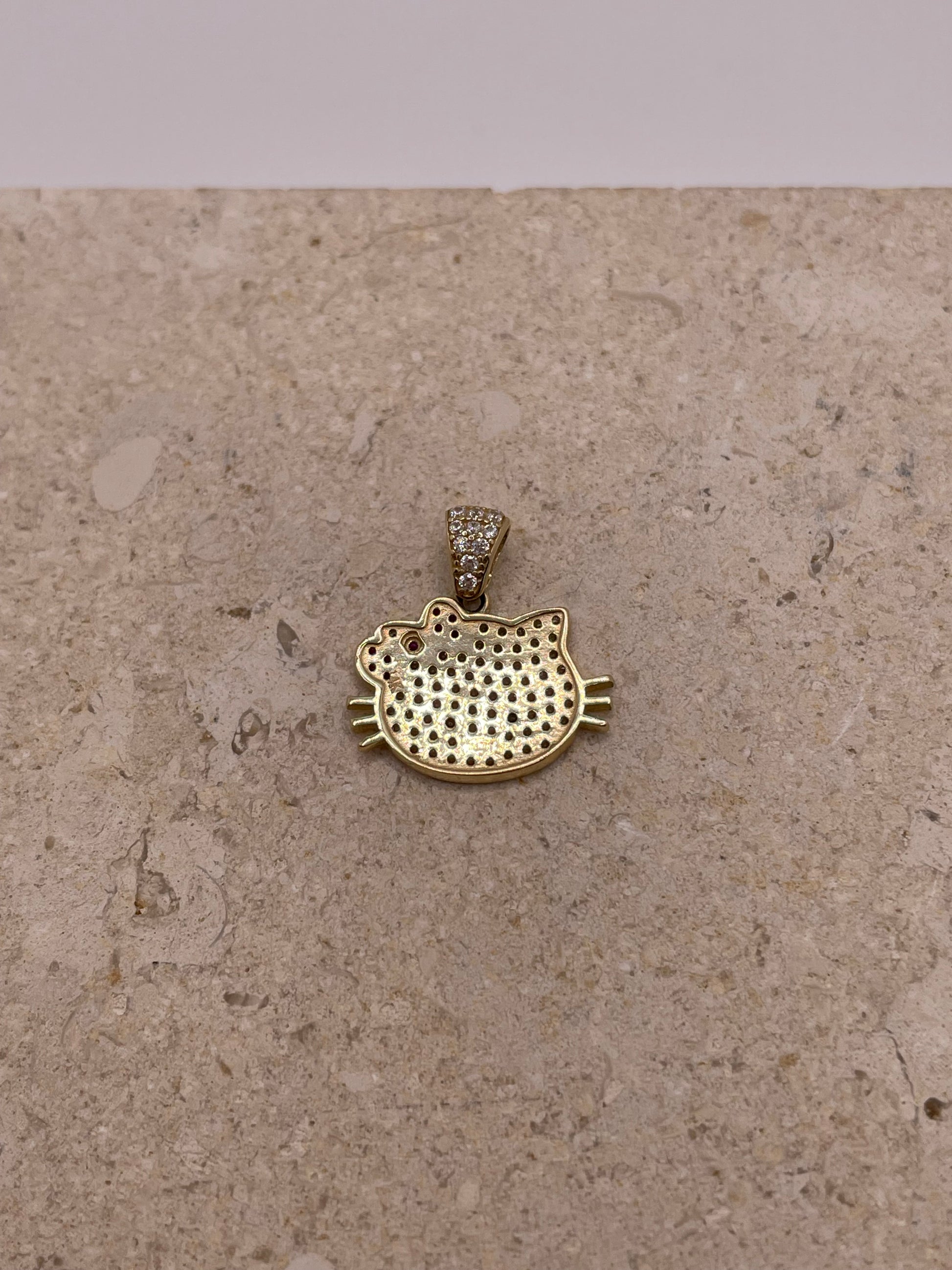 Back view of 14K gold Hello Kitty pendant with smooth polished finish