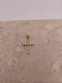 Close-up of 14K yellow gold cross pendant with white CZ stones, showing intricate details and design