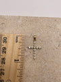 14K yellow gold CZ cross pendant shown next to a ruler to display dimensions, including bail (1 inch).