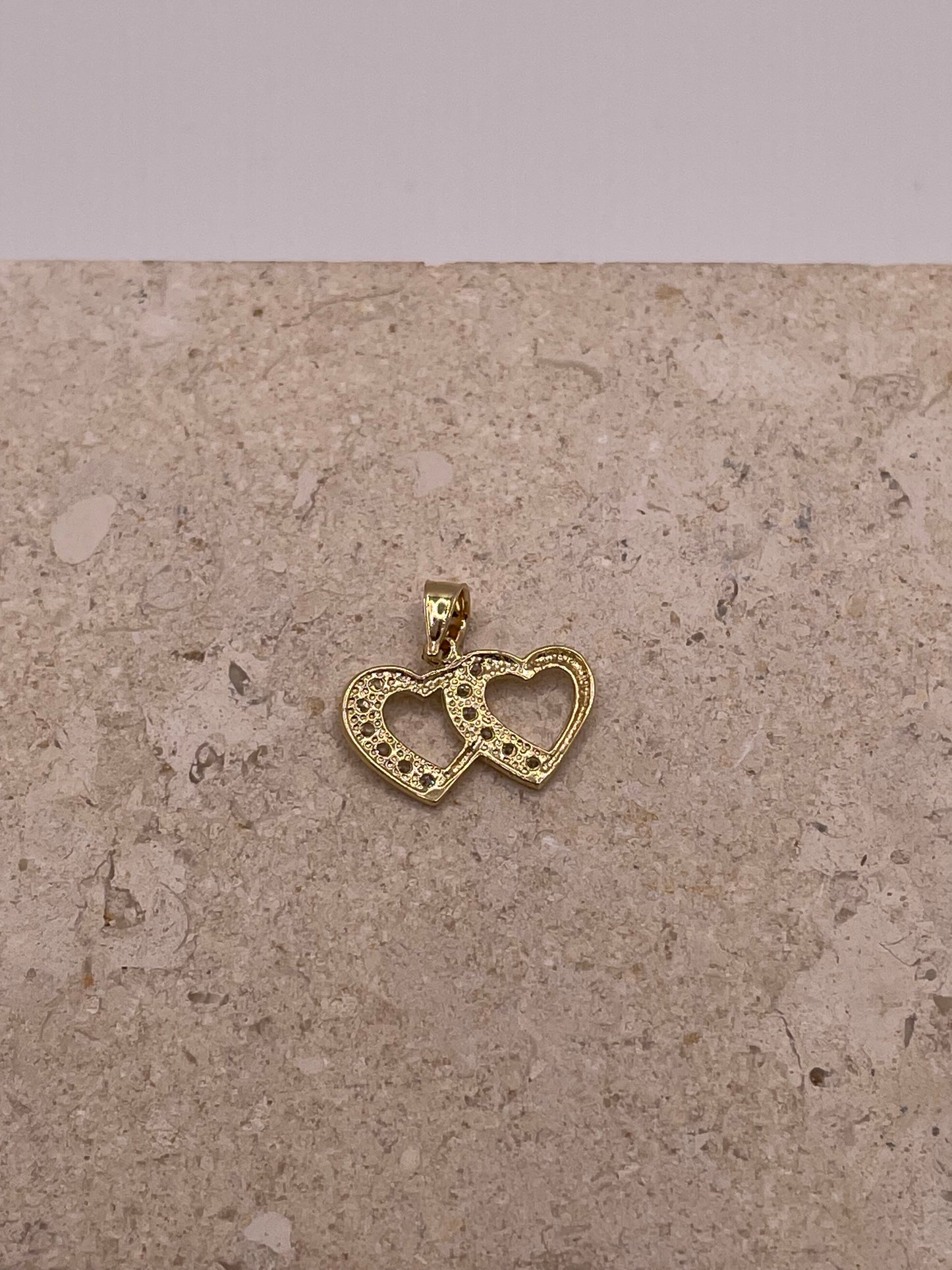 Back view of 14K gold double heart link pendant with smooth polished finish