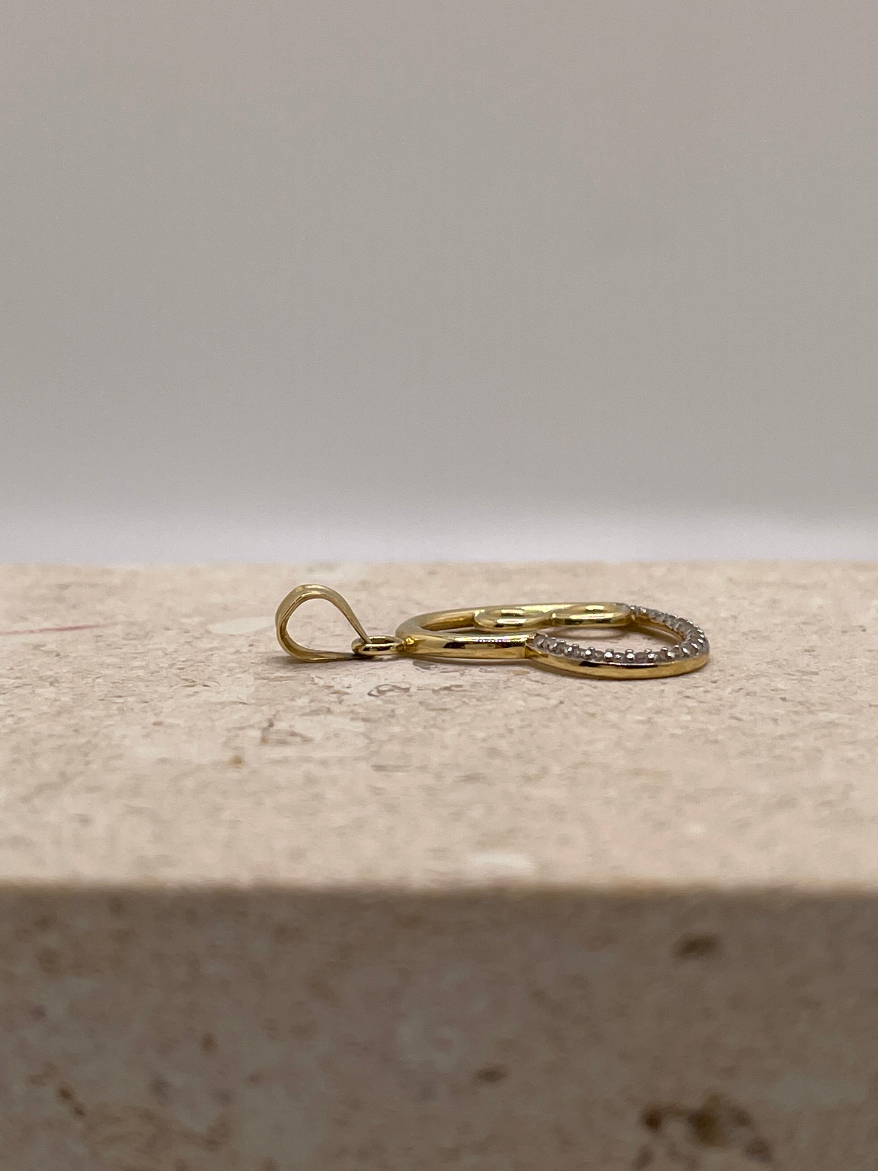 Side view of 14K gold open heart pendant showing the bail position and detailed design