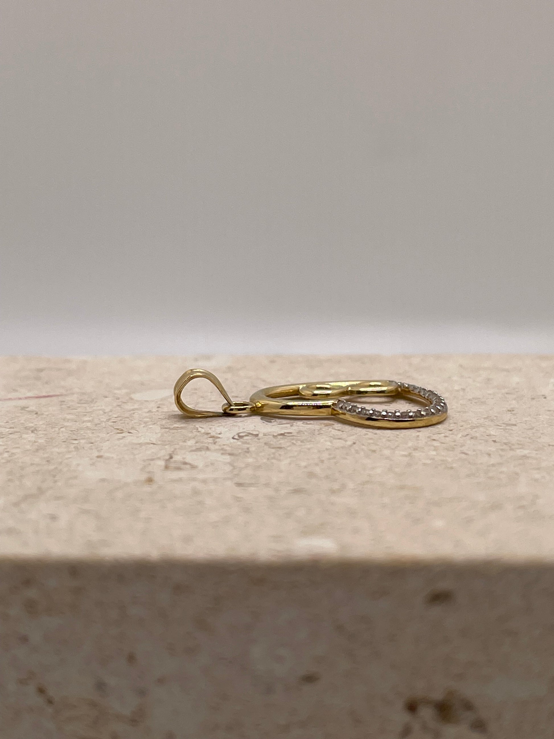 Side view of 14K gold open heart pendant showing the bail position and detailed design