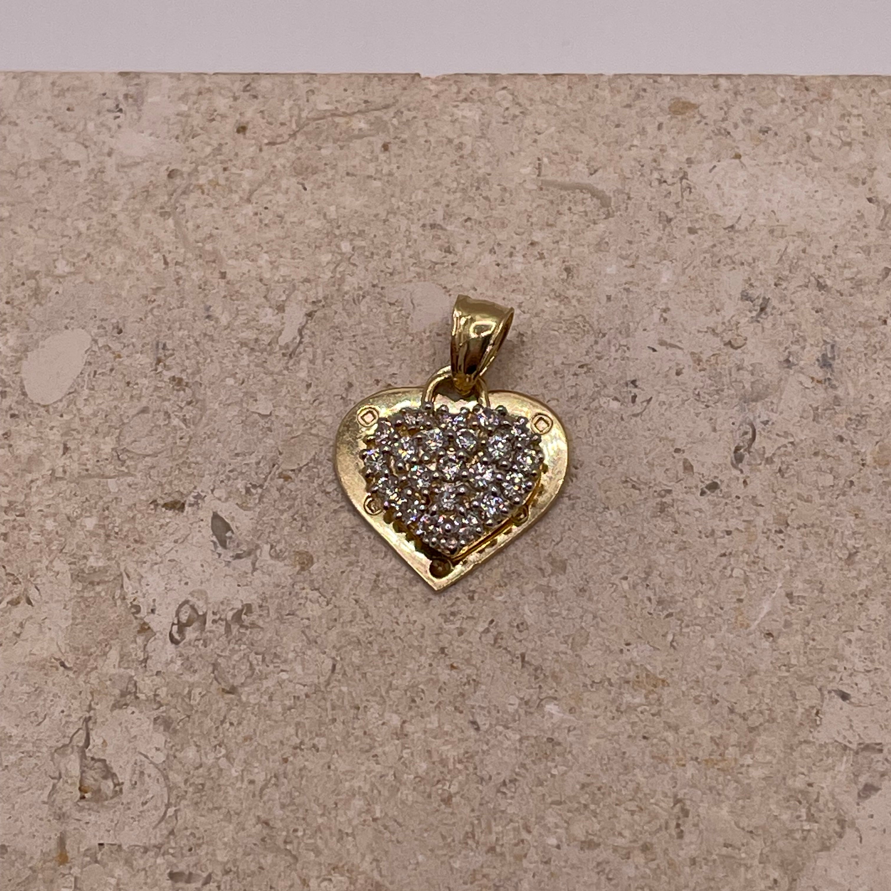A close-up image showing the 14k gold "I Love You" heart pendant with the detailed cut-out design and sparkling cubic zirconia stones in the top heart. The delicate engraving of "I love you" is clearly visible on the gold heart