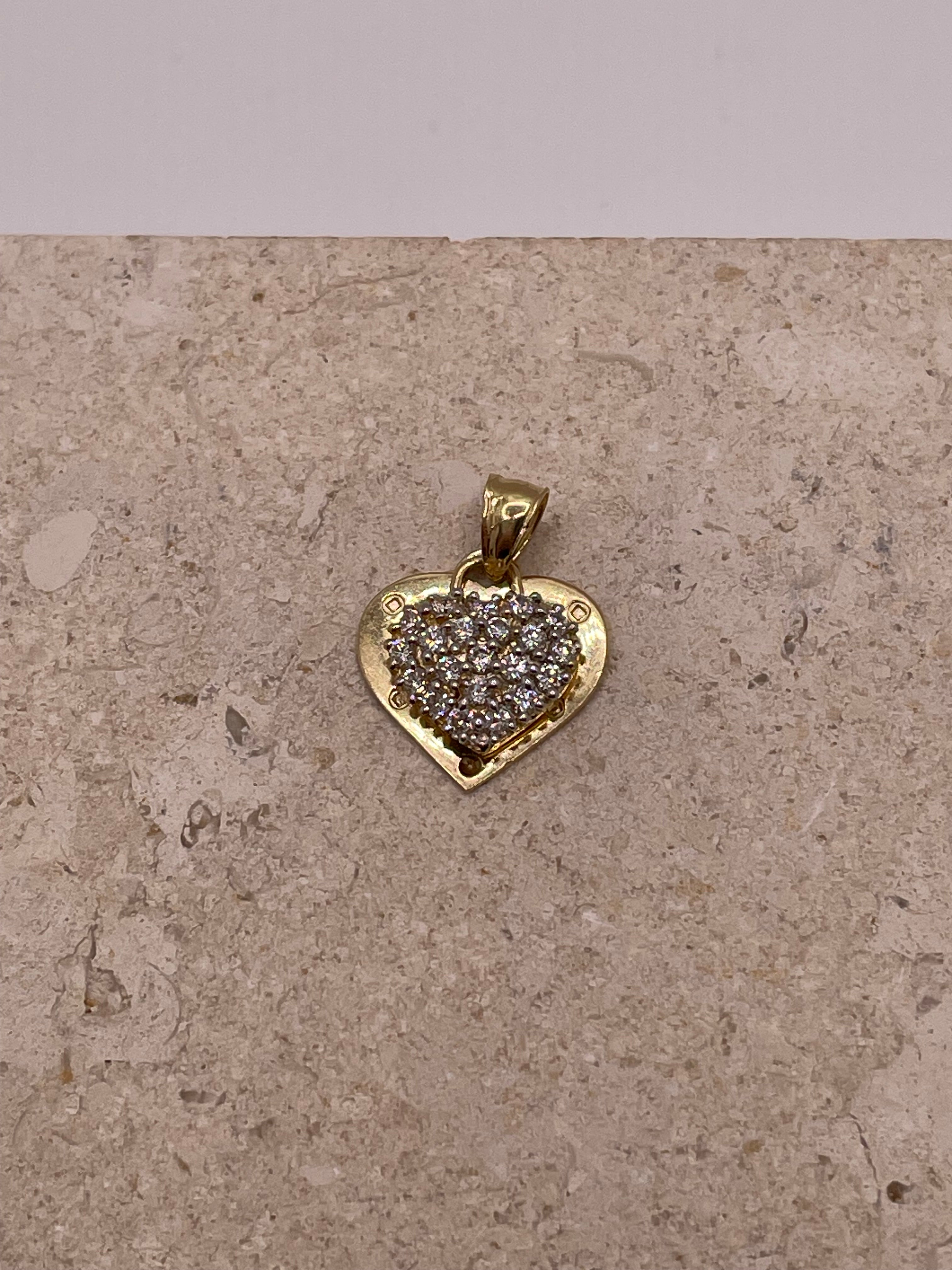 A close-up image showing the 14k gold "I Love You" heart pendant with the detailed cut-out design and sparkling cubic zirconia stones in the top heart. The delicate engraving of "I love you" is clearly visible on the gold heart